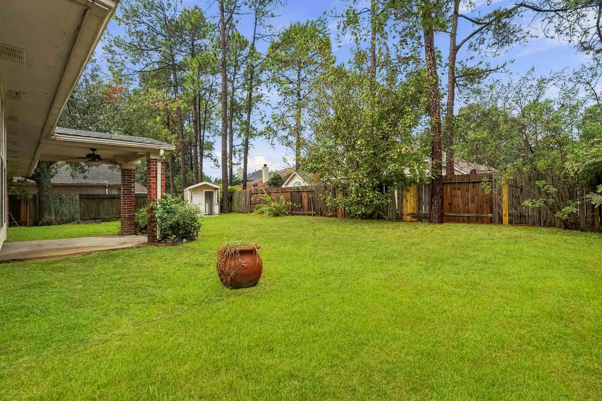 14319 Floret Estates Court, Cypress, TX 77429 Enjoy a large backyard with a covered patio, perfect for relaxing or entertaining.