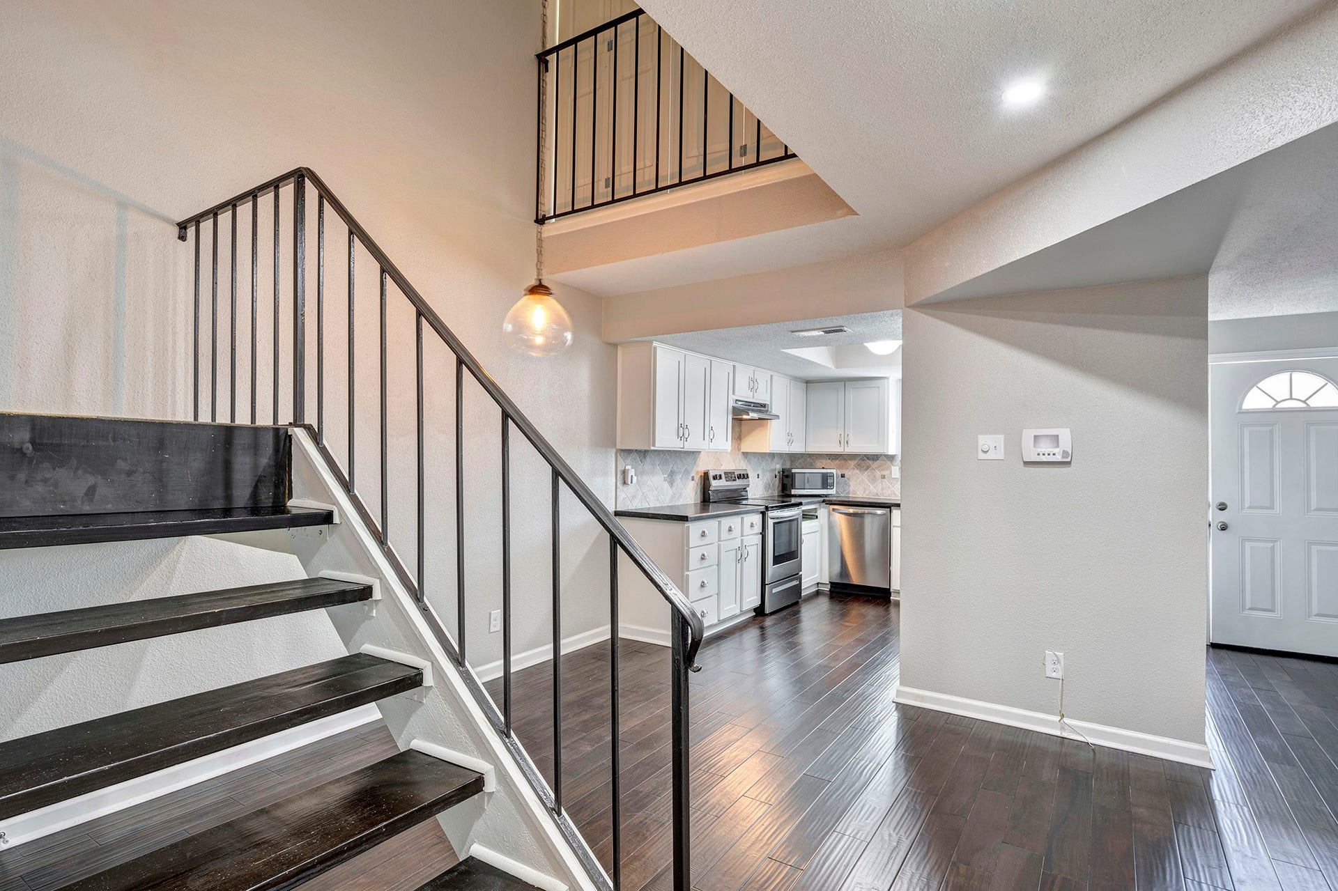 5005 Georgi Lane, #165, Houston, TX 77092 Great open floorplan with vaulted ceiling. View of staircase through dining to kitchen.
