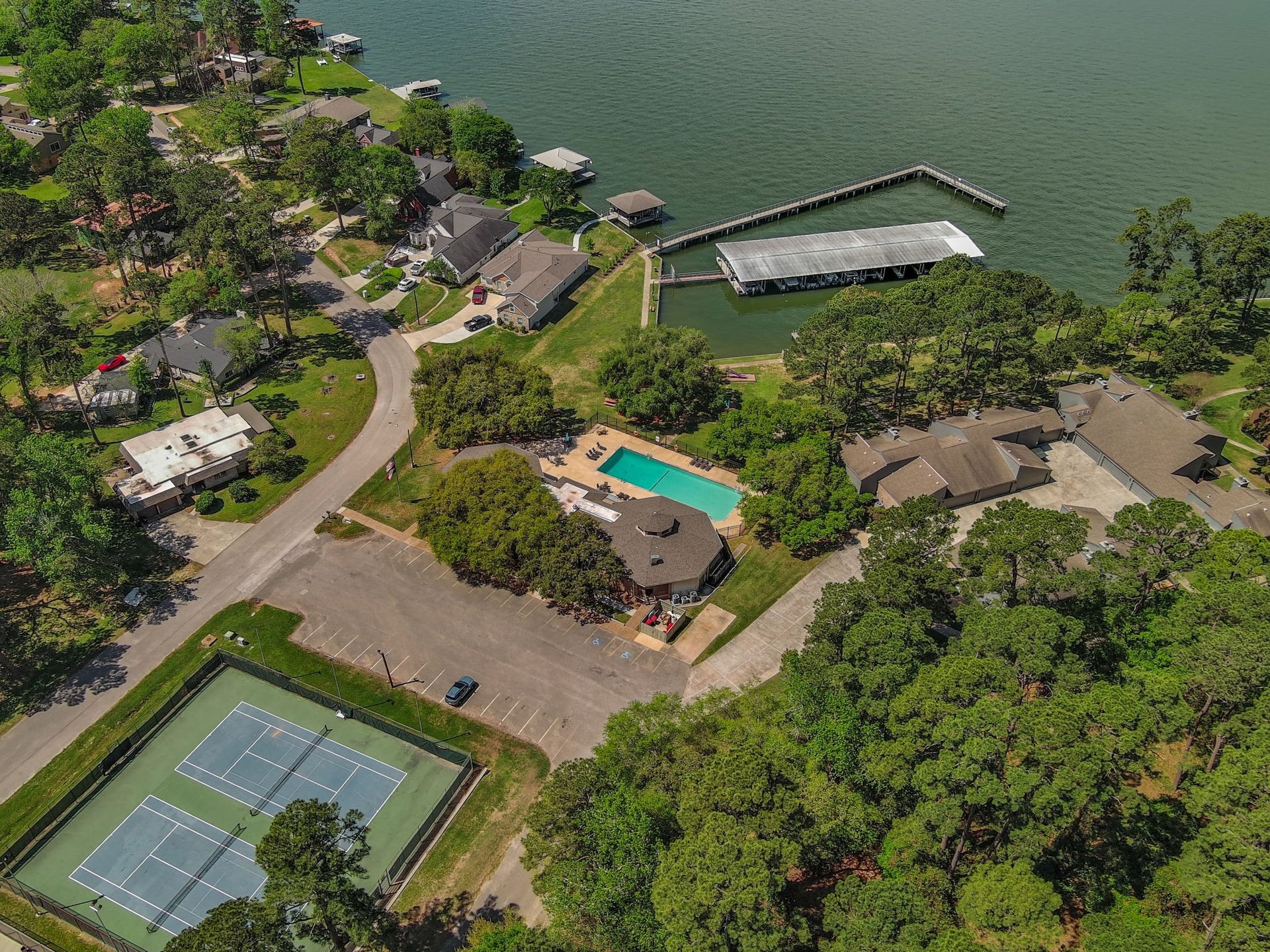 View of the tennis courts, community pool, fishing pier and boat slips.