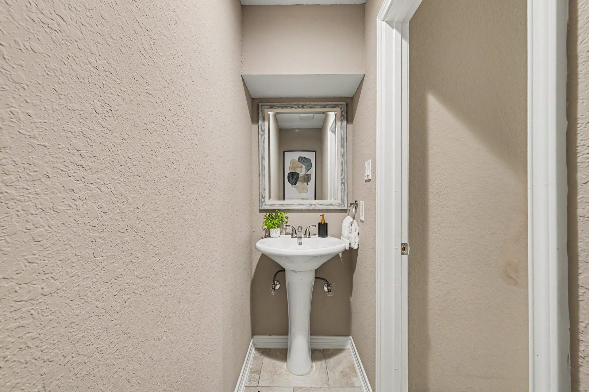 The first-floor half bath for guests is tucked away near the large understairs storage closet.