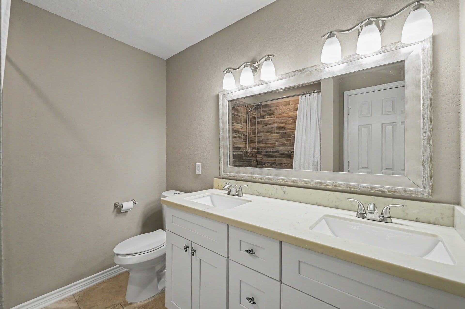 Bedrooms 3 and 4 share the 3rd full bath with dual sinks.