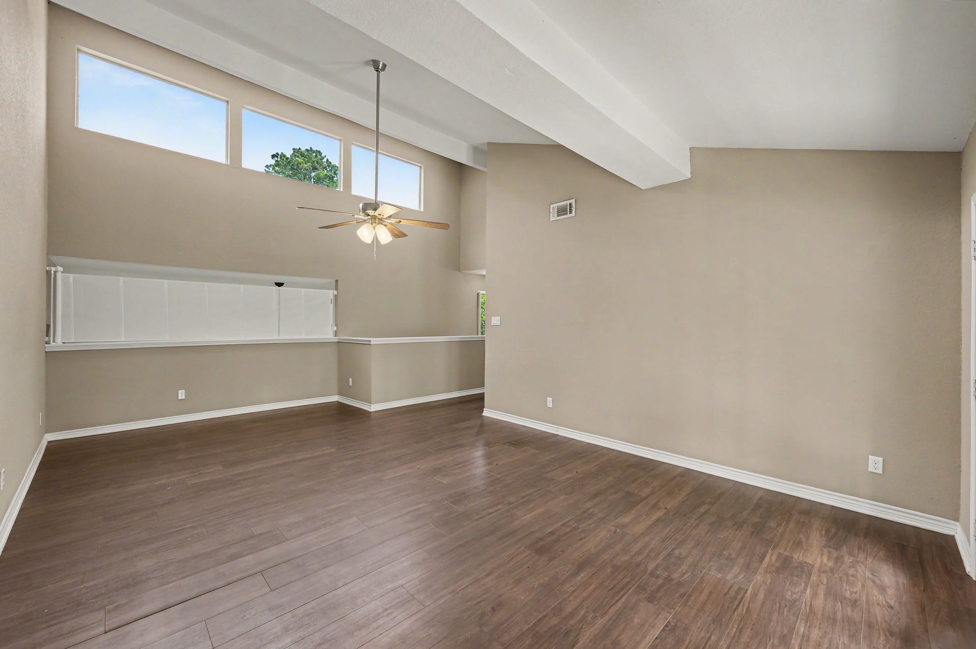 Sellers recently had the beautiful Clerestory windows tinted to reduce heat while allowing natural light to continue to fill the space. Retractable mesh safety curtain shown across the loft overlook.