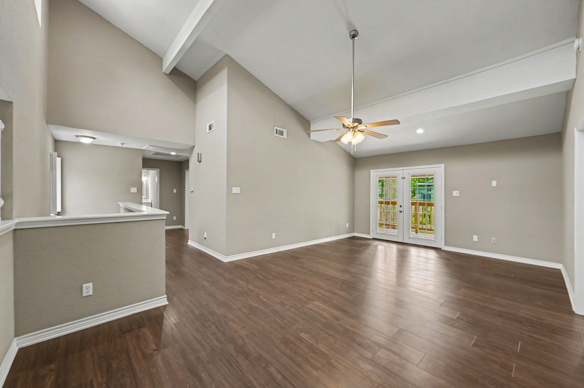 Upstairs family room with French doors leading to the recently painted balcony.