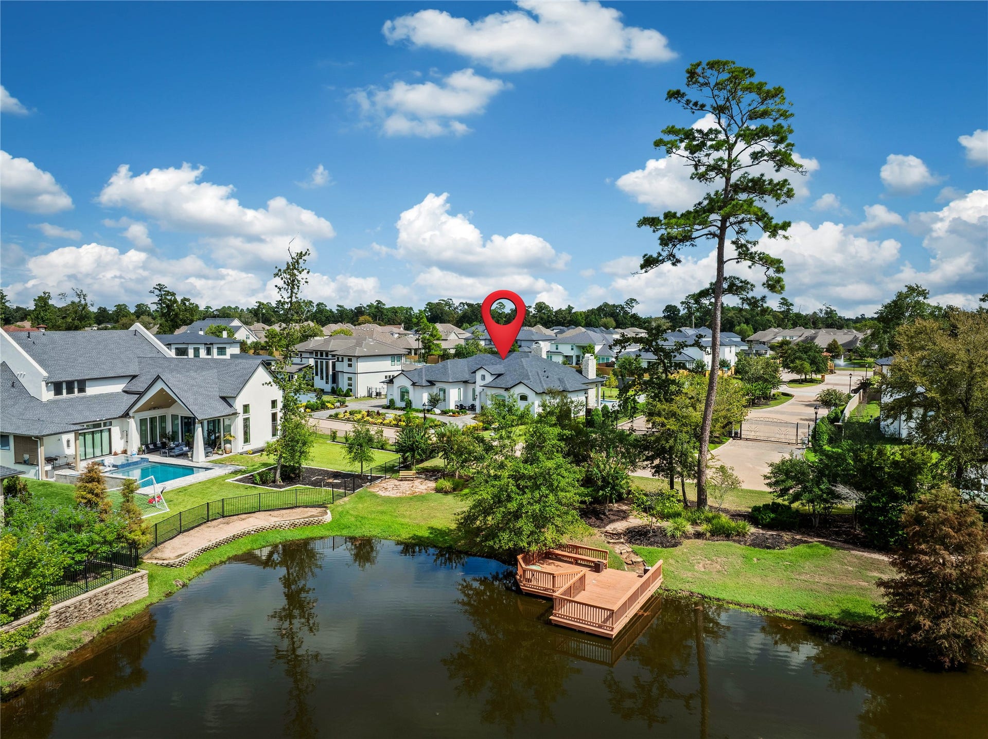 24718 Shadow Pond Drive, Spring, TX 77389 Charming home nestled in a serene neighborhood features a private deck overlooking a tranquil pond, perfect for relaxation and enjoying nature.