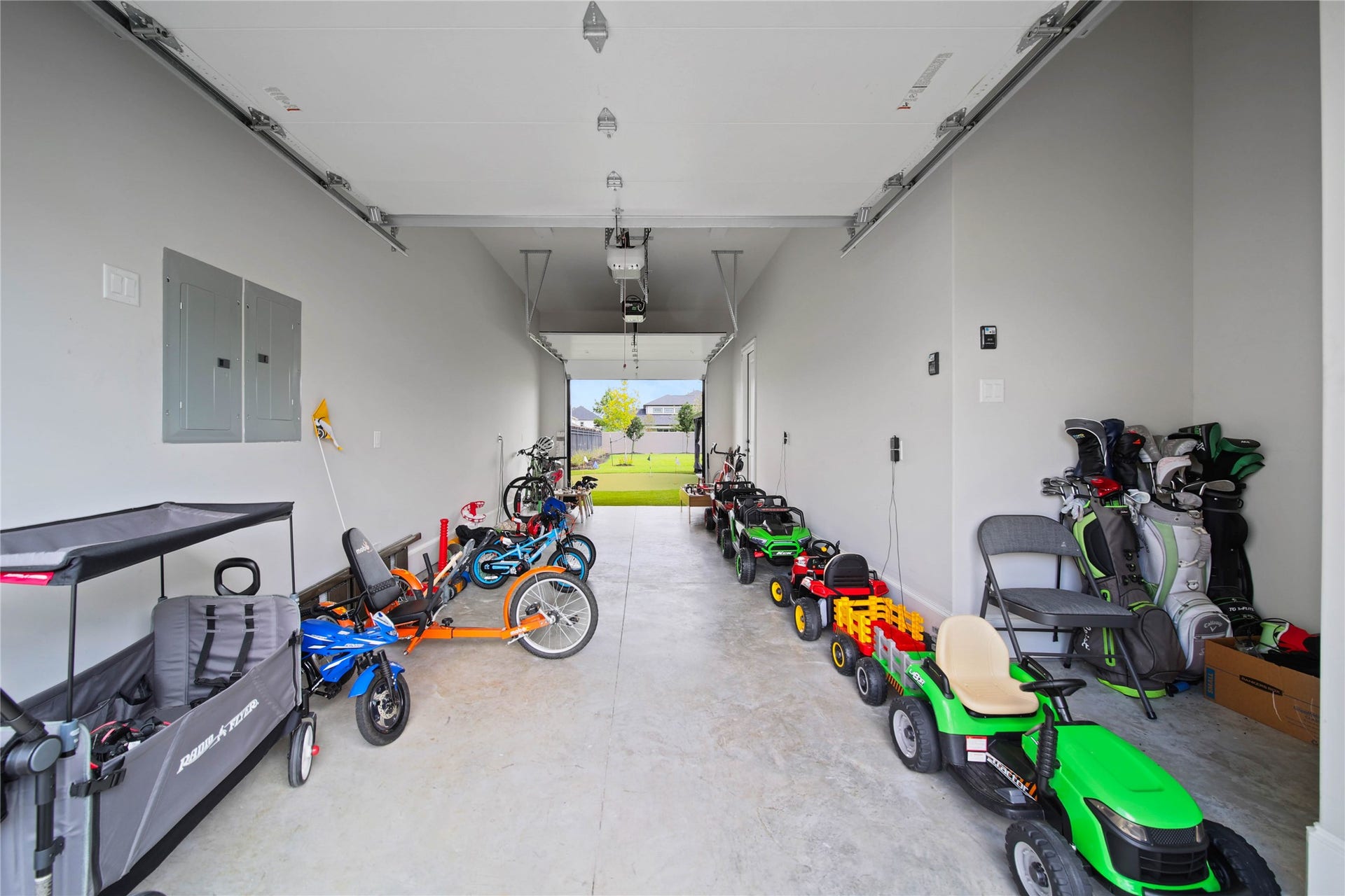 24718 Shadow Pond Drive, Spring, TX 77389 Spacious garage with ample room for storage and recreational equipment, leading to a lush backyard.