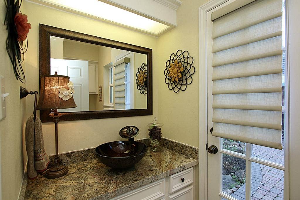 15914 Harwick Drive, Spring, TX 77379 REMODELED POWDER BATH WITH VESSEL SINK OPENS TO BACKYARD. Powder bath has granite counters and vessel sink. Custom painted cabinets. Easy access to the backyard pool & spa, garage, laundry and kitchen area.