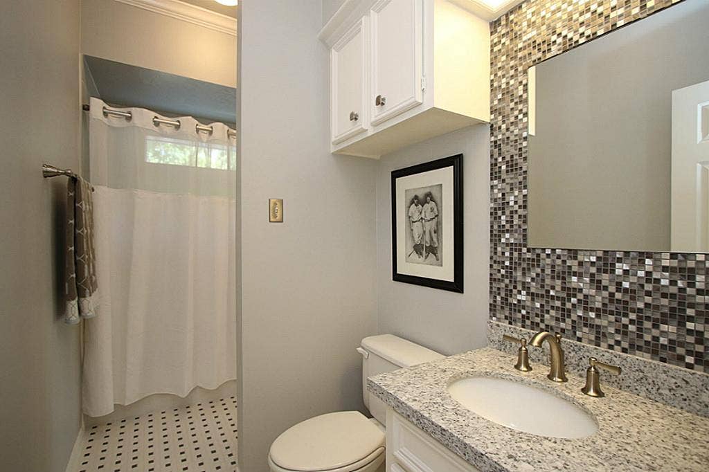 15914 Harwick Drive, Spring, TX 77379 SECOND FULL BATHROOM UPSTAIRS NICELY REMODELED All bathrooms have been tastefully remodeled with neutral granite vanities, new sinks, faucets and tile flooring. This bathroom has a tiled mirror wall for an added design feature.