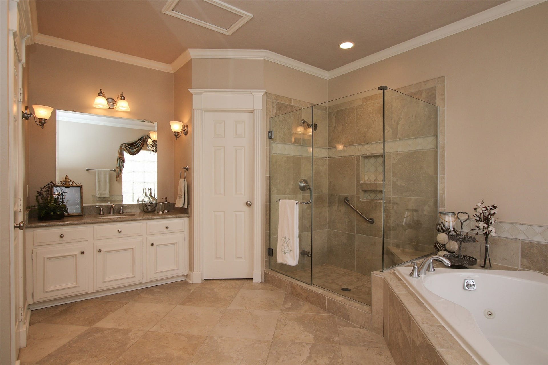 15914 Harwick Drive, Spring, TX 77379 MASTER BATHROOM WITH DUAL GRANITE VANITIES AND TWO LARGE WALK IN CLOSETS. This view of the Bathroom shows the Second Vanity. The other Vanity has a sitting space. The large window that is over the tub (as seen in the mirror) brings in great natural light. Large Walk in shower with frameless glass enclosure and new Silver Nickle Faucets.