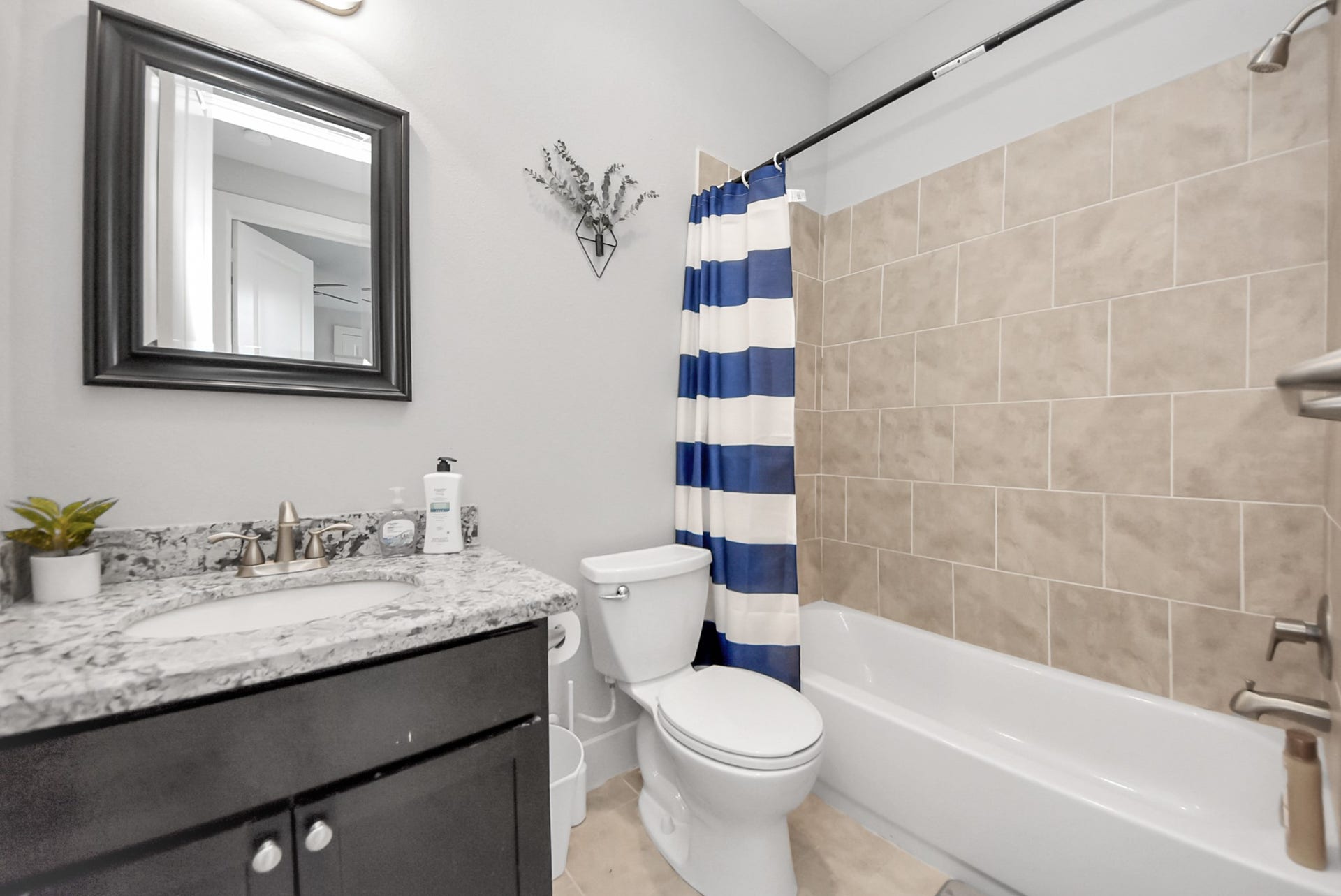 1706 Spring Street, Houston, TX 77007 Full secondary bathroom featuring granite countertop, tub/shower combination, and neutral finishes.