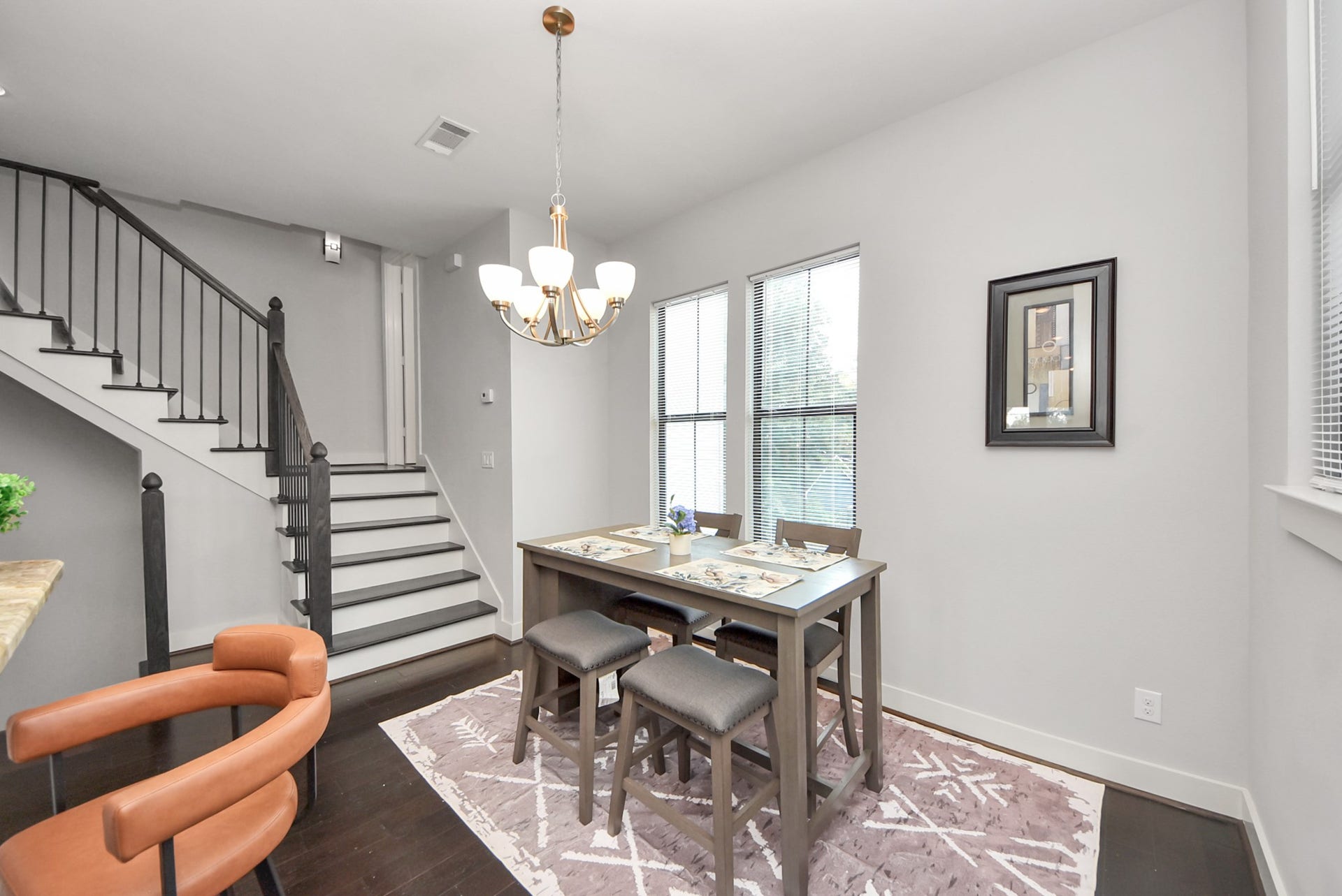 1706 Spring Street, Houston, TX 77007 Light-filled dining area surrounded by windows and accented by a stylish chandelier.