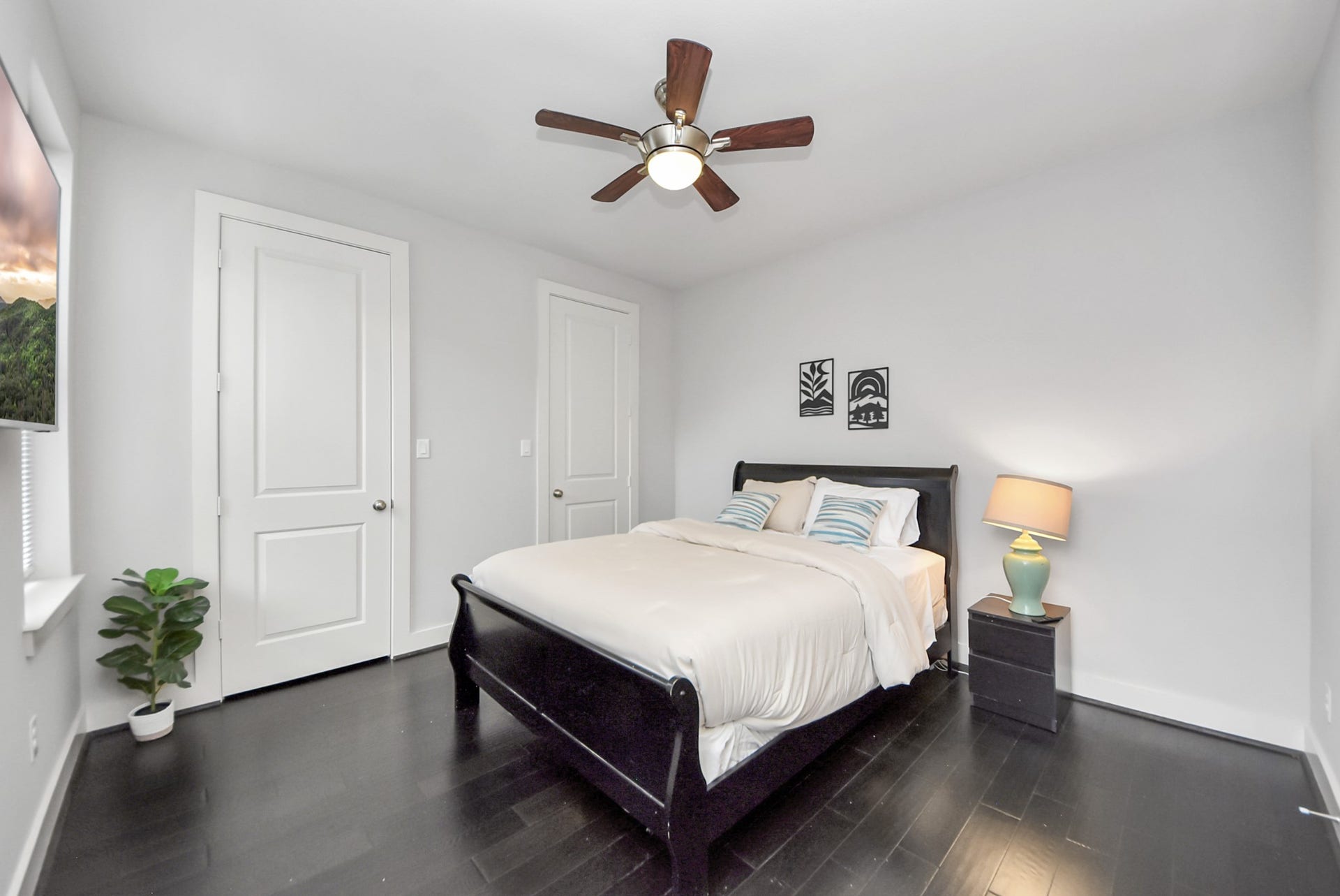 1706 Spring Street, Houston, TX 77007 Spacious secondary bedroom with dark wood flooring, ceiling fan, and clean contemporary finishes.