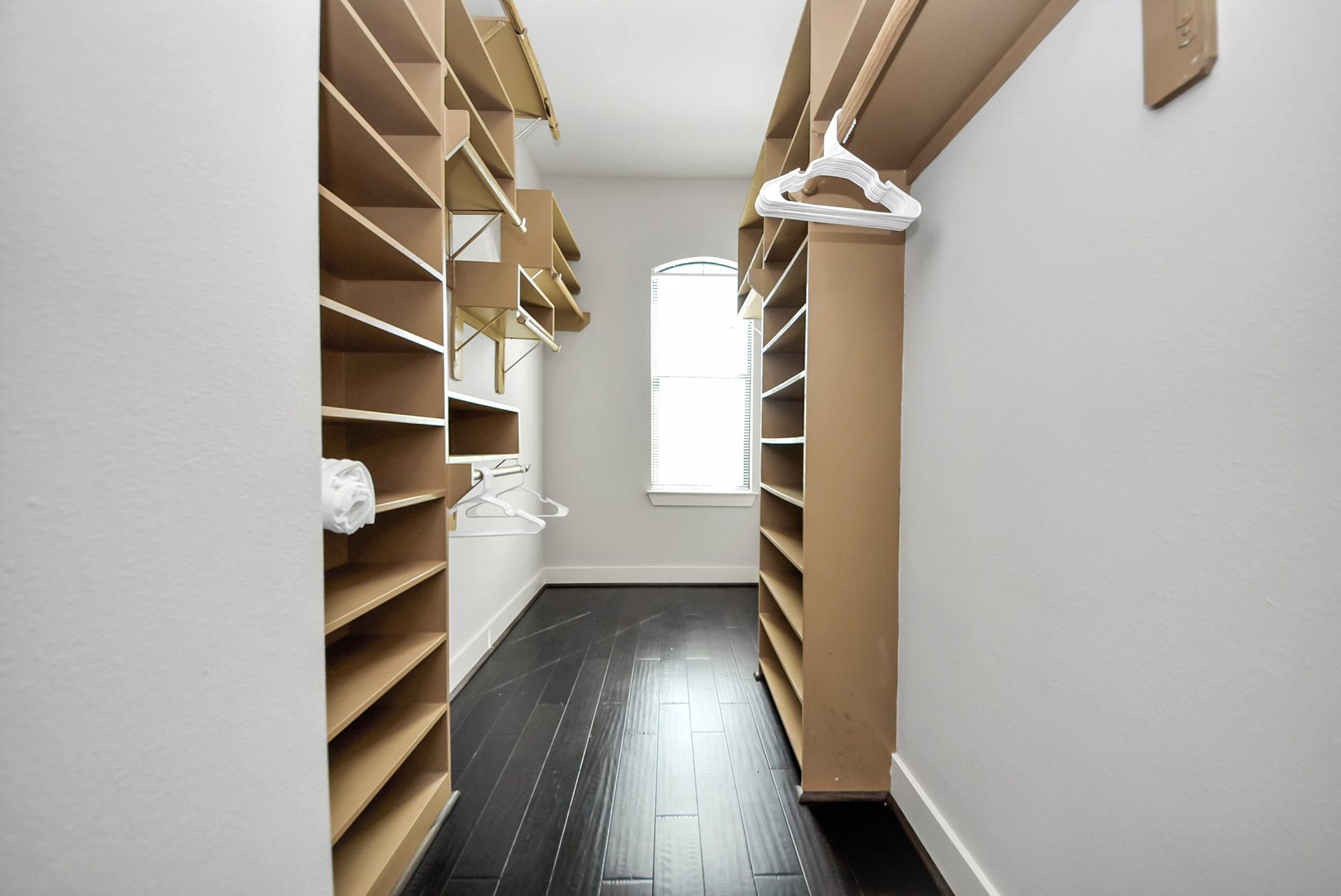 1706 Spring Street, Houston, TX 77007 Oversized walk-in closet with extensive built-in shelving, hanging space, and natural light.