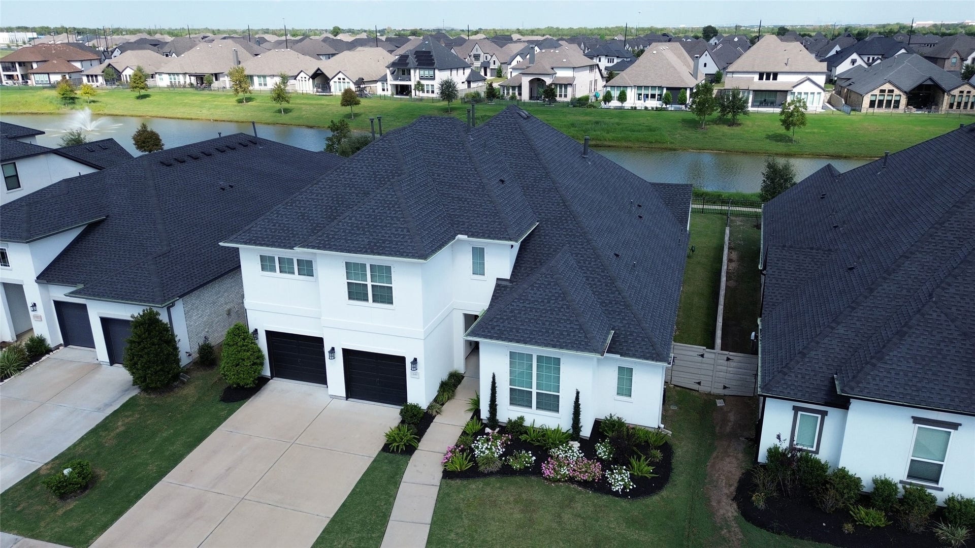 Your home features an expansive driveway and oversized three-car tandem garage, offering ample space for parking and storage.