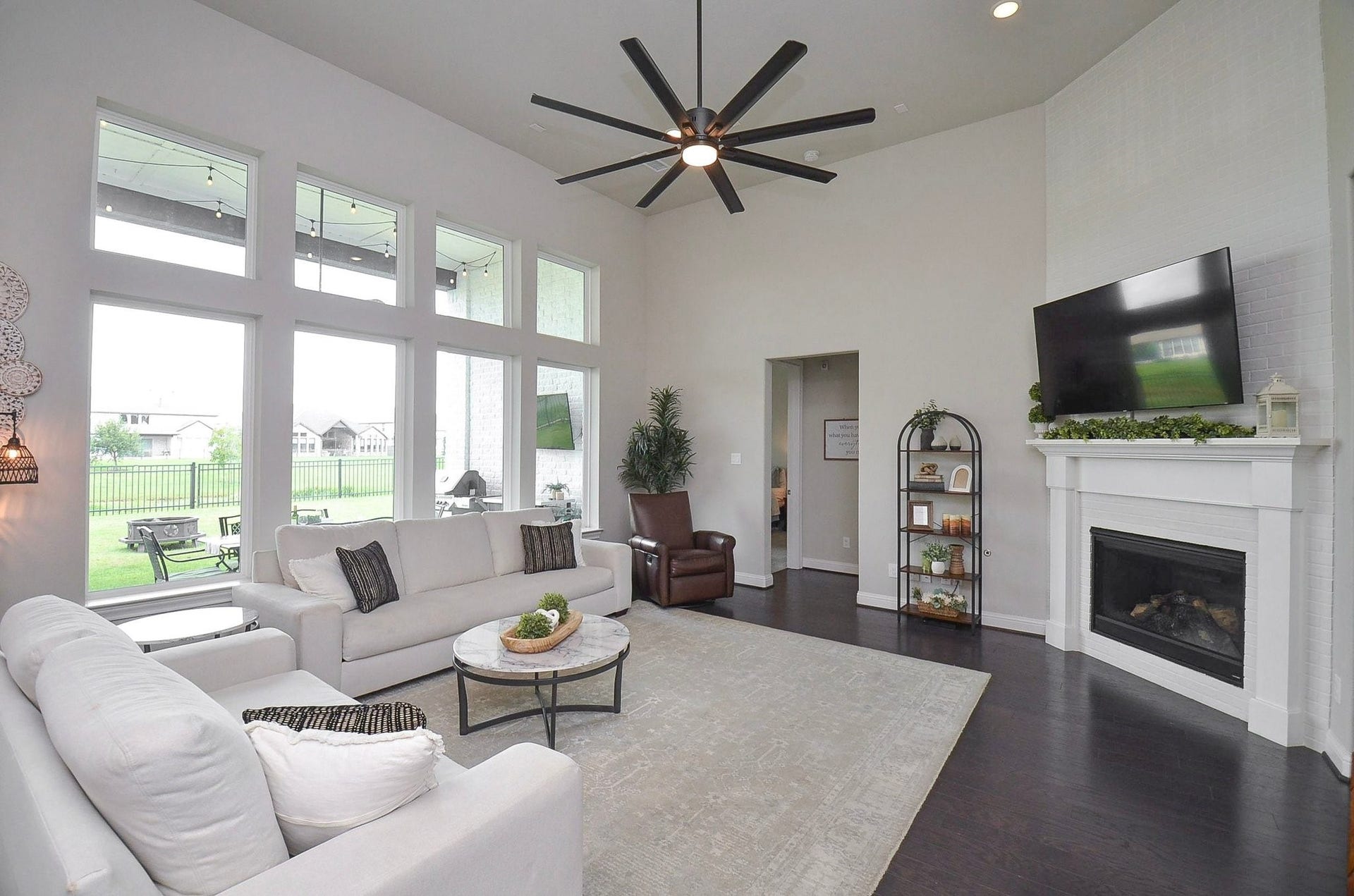 Soaring ceilings and expansive transom-topped windows fill your 19' x 19' living room with natural light while framing beautiful lake views. A cozy gas fireplace with a mantel offers the perfect spot to hang your holiday stockings and display your favorite family photos.