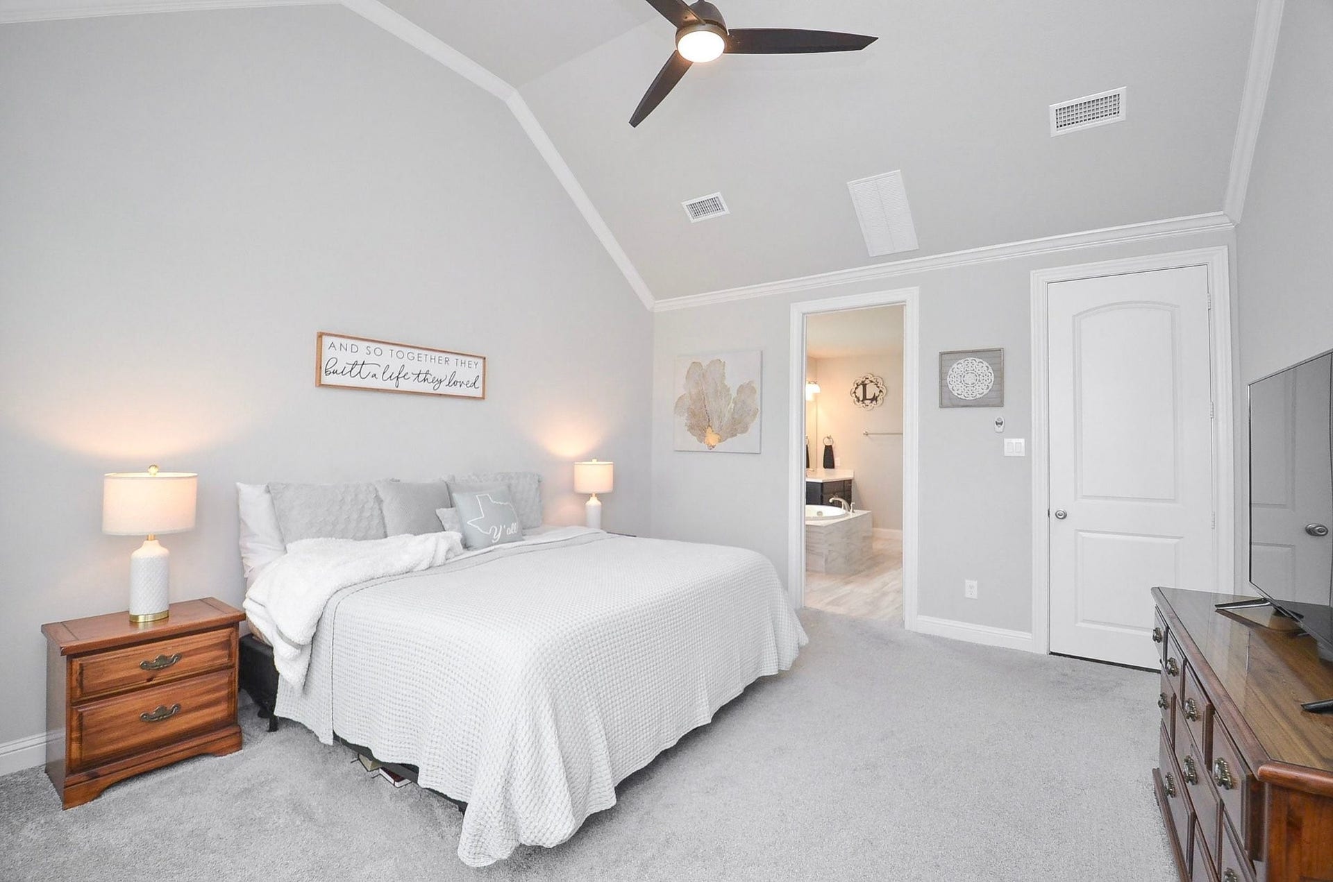 Vaulted ceilings add an airy, elegant feel to your primary bedroom, while soft carpeting and a ceiling fan provide everyday comfort.  Come visit the home and see the enormous closet that's perfect for newborn days as a nursery!