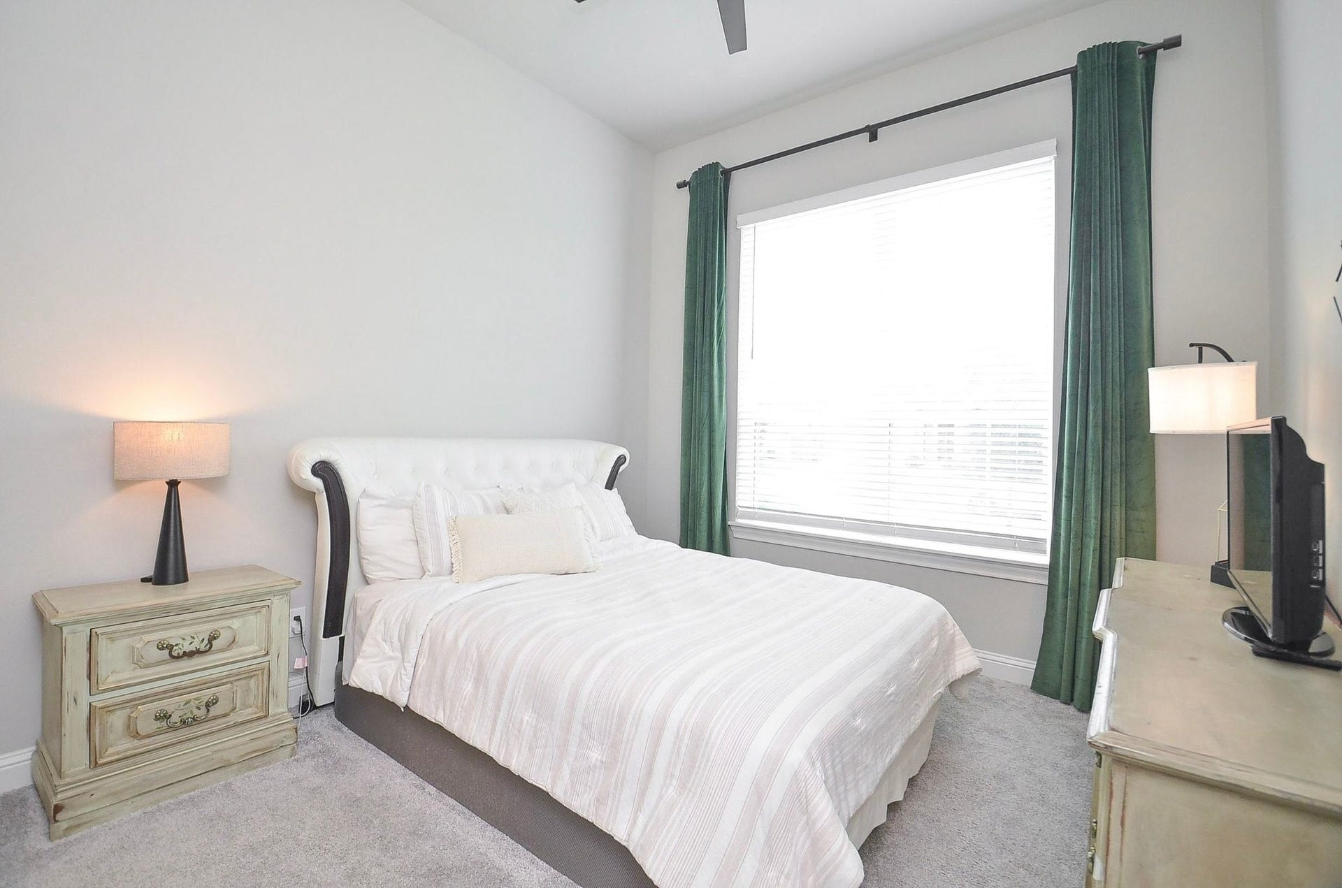 Measuring 11' x 12', this inviting guest bedroom offers plenty of room for a full or queen-size bed. A large window welcomes natural light and soft carpet adds everyday comfort.