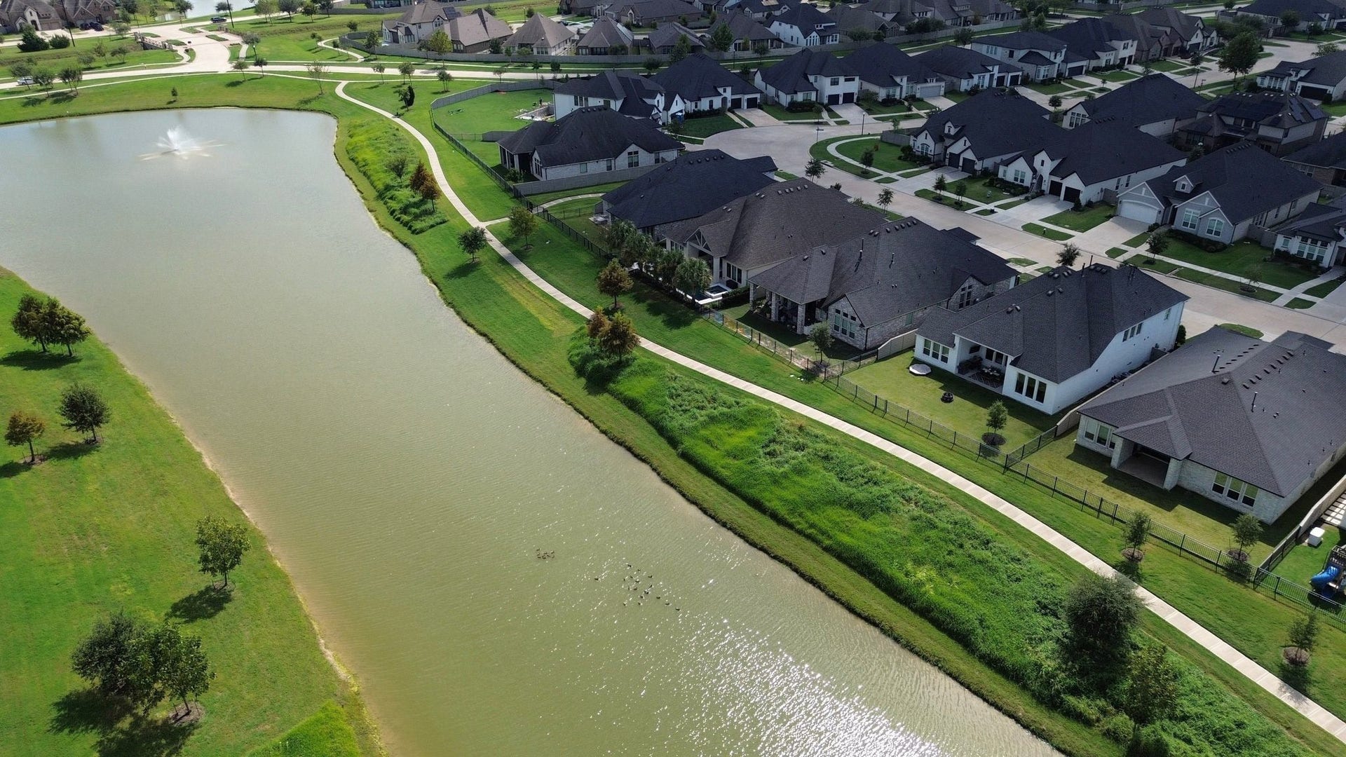 Enjoy the beauty of a premium lakeside lot, with peaceful mornings overlooking the water and evening strolls along scenic walking trails.
