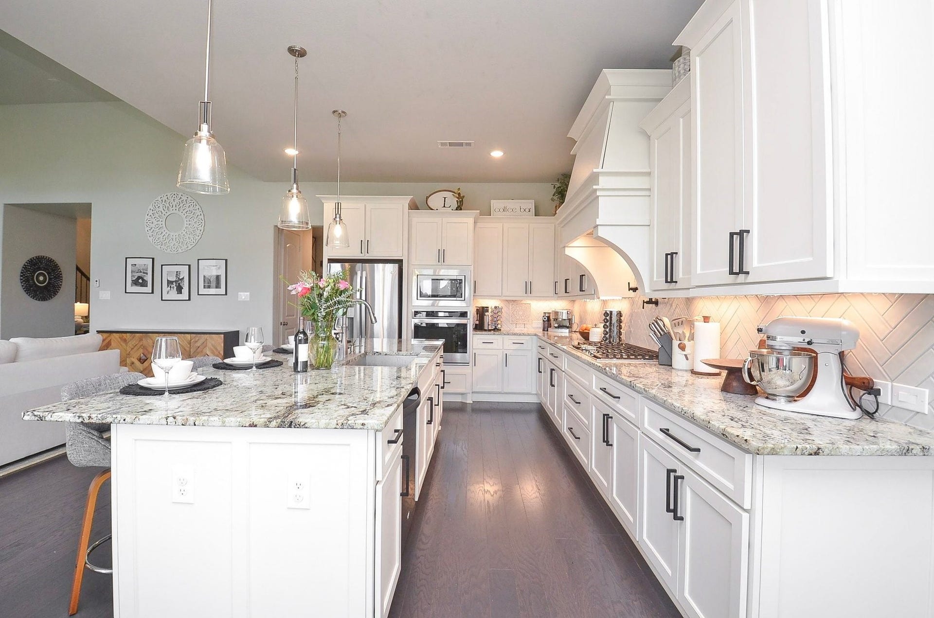 Bring your favorite recipes to life in your 14' x 19' chef-inspired kitchen, featuring elegant white cabinetry, granite countertops, stainless steel appliances, a gas cooktop, and a convenient pot filler.