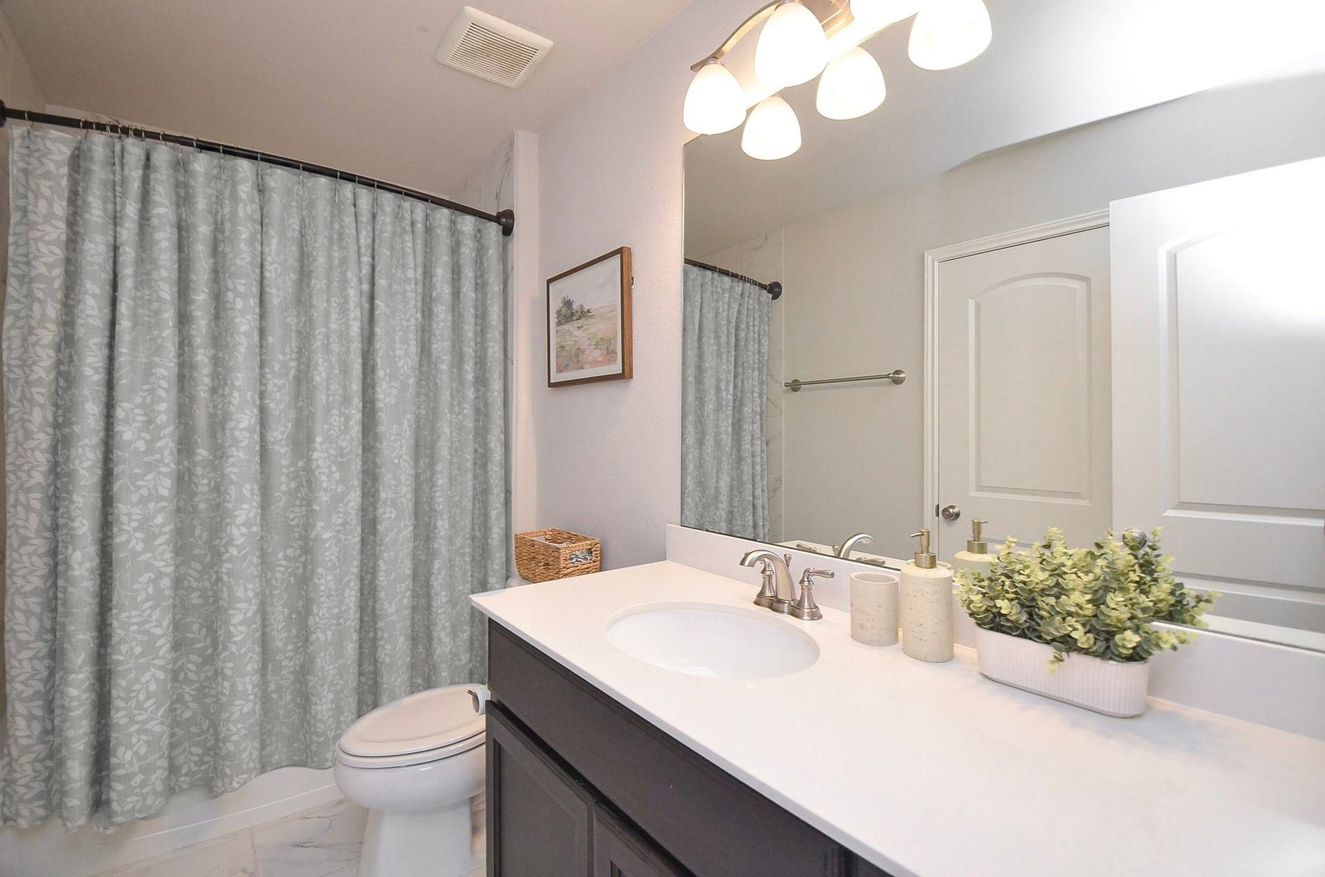 Every bedroom in your home enjoys the convenience of its own bathroom. This 6' x 10' upstairs full bath features a spacious vanity, cabinet storage, and light, timeless finishes.