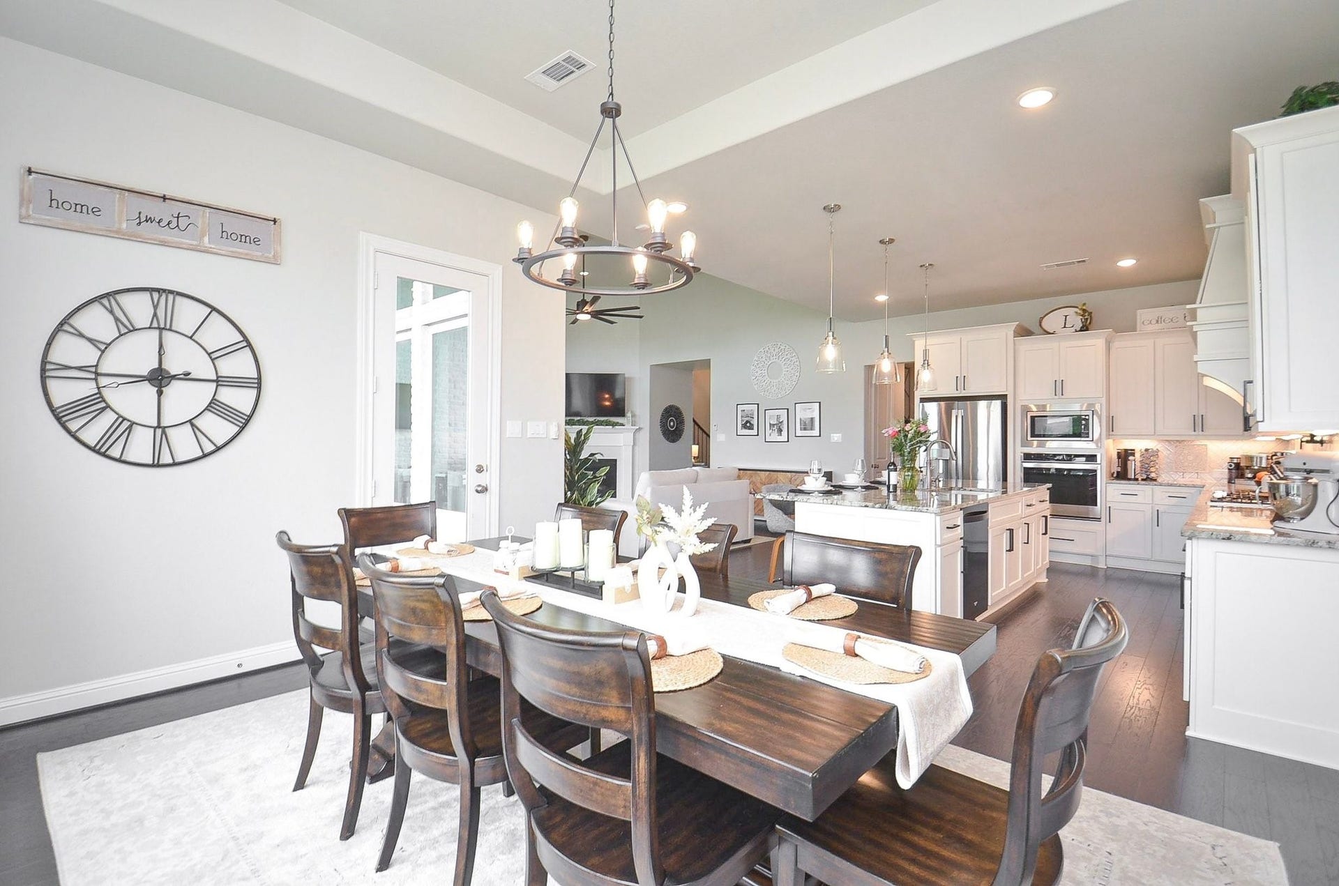 Your light-filled 14' x 12' dining area, seamlessly connected to the kitchen and living room. Large windows and a nearby glass door frame beautiful backyard views, creating an inviting setting for everyday meals and special gatherings with all of your favorite people.