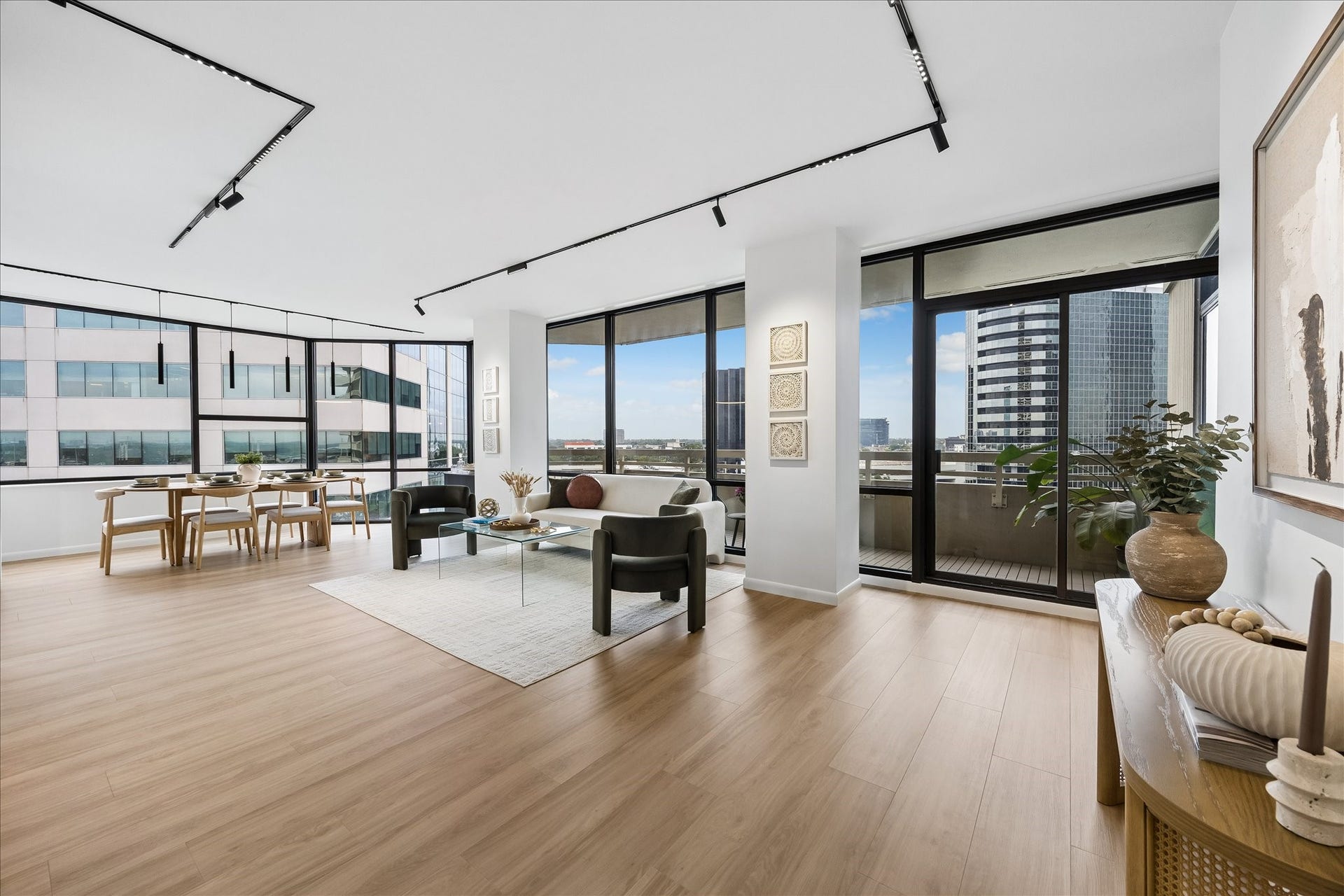 14 Greenway Plaza, #9R, Houston, TX 77046 Expansive windows connect open living and dining areas with city views and balcony access.