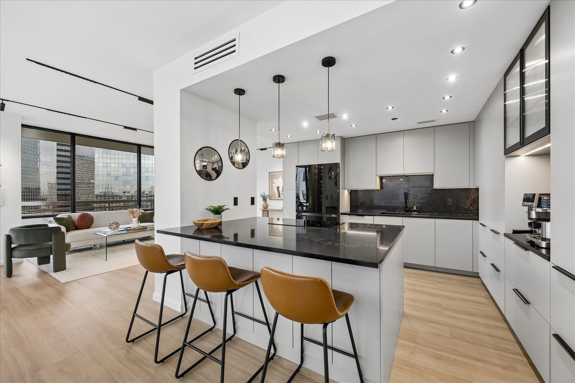 14 Greenway Plaza, #9R, Houston, TX 77046 Kitchen island connects preparation space with the adjoining living areas. Marble-effect glass composite countertops and backsplash complement a Samsung four-door Flex refrigerator with remote app control.