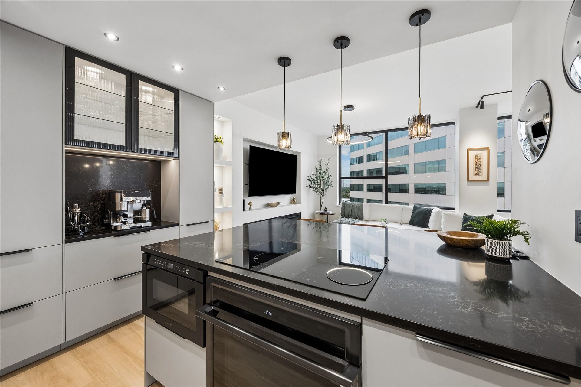 14 Greenway Plaza, #9R, Houston, TX 77046 Induction cooktop, Samsung single oven with remote app control and built-in microwave drawer place cooking within the open kitchen. Marble-effect glass composite countertops and backsplash frame the coffee/bar nook.