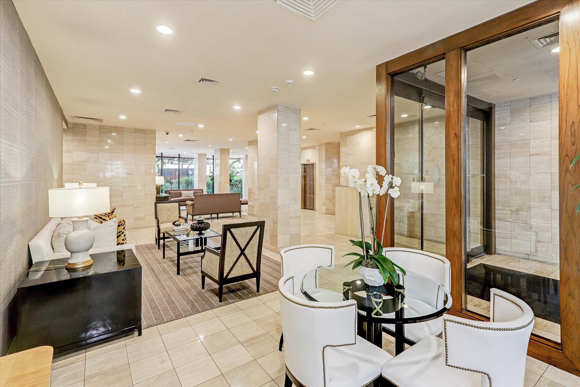 14 Greenway Plaza, #9R, Houston, TX 77046 Multiple seating areas extend through the lobby, where wood-framed glass doors, coordinated furnishings and warm finishes create a polished setting for everyday arrivals.