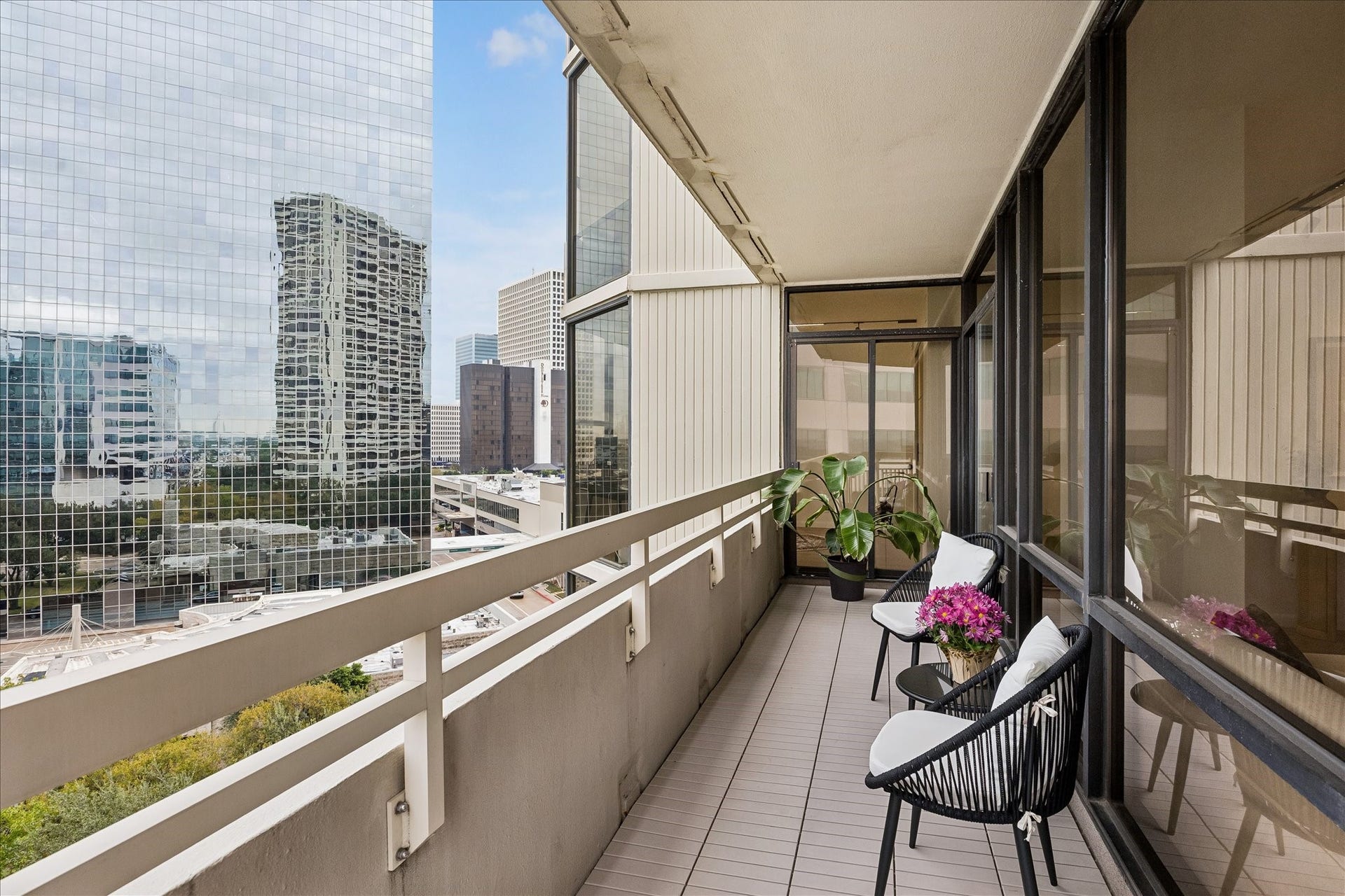 14 Greenway Plaza, #9R, Houston, TX 77046 Balcony extends alongside the living room windows and connects to the corner bedroom.