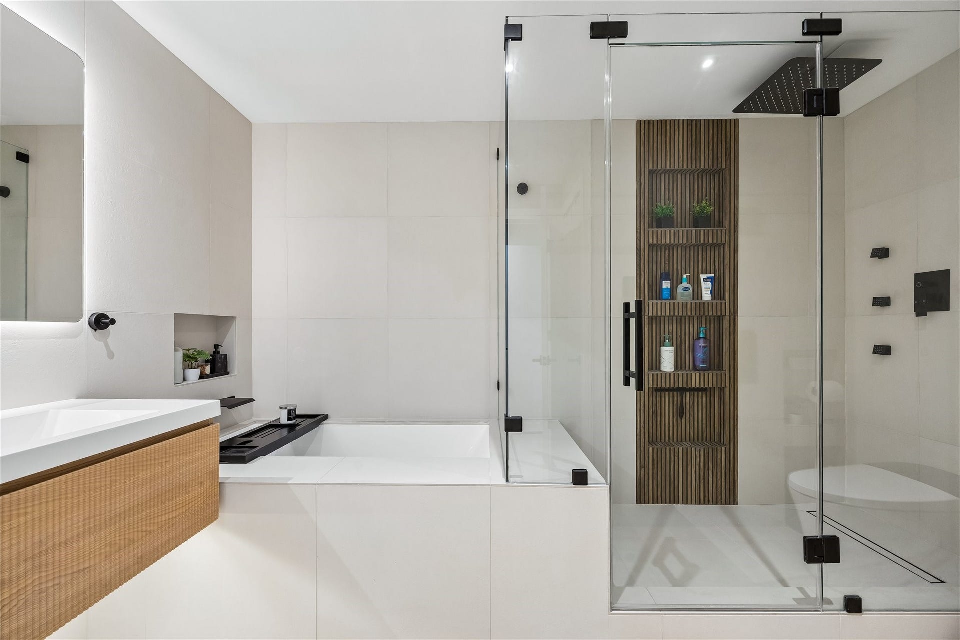 14 Greenway Plaza, #9R, Houston, TX 77046 Separate bathtub and glass enclosed shower offer distinct bathing spaces, with recessed storage within reach.