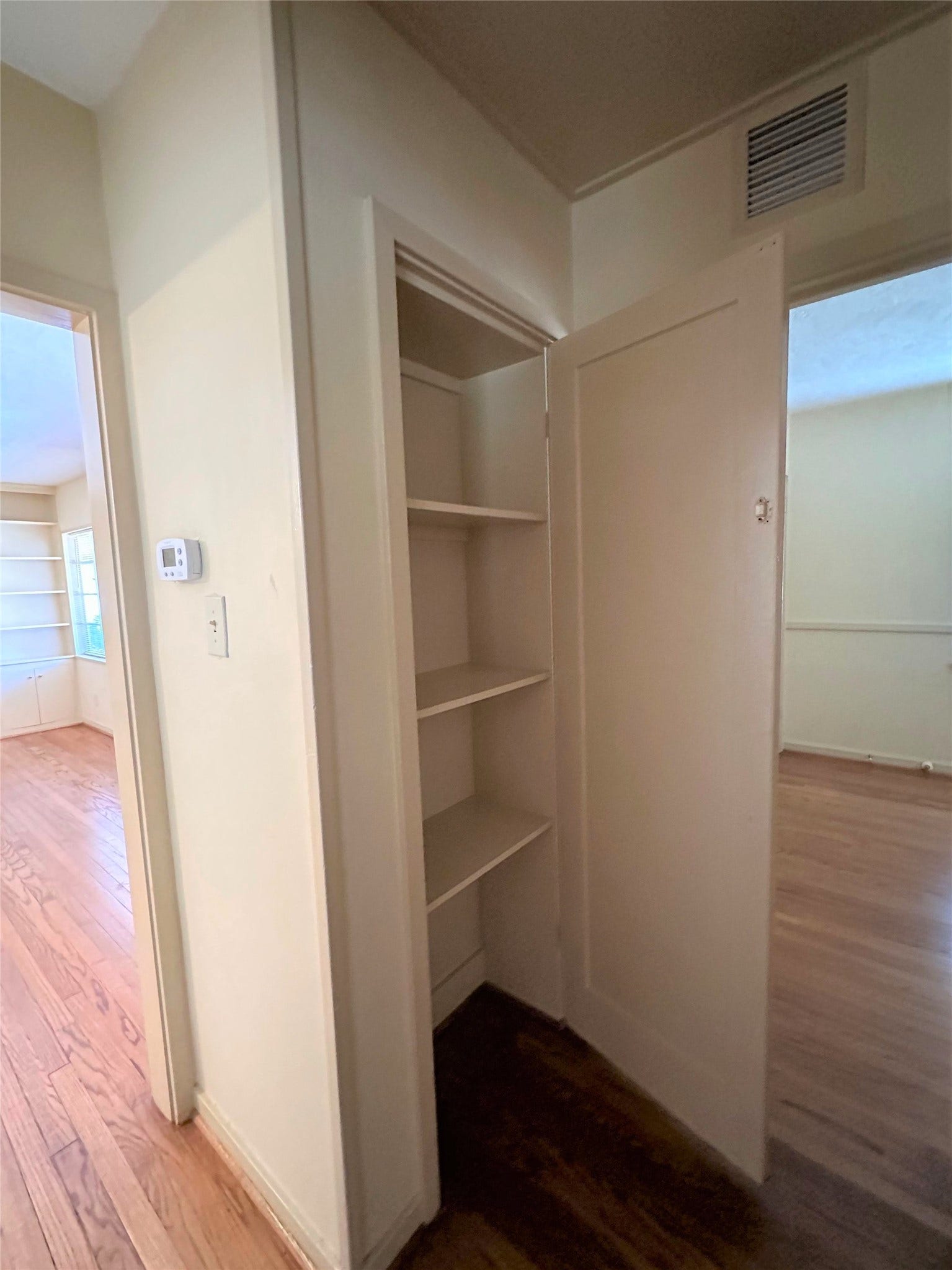 Hallway off front living room leads to the secondary bedrooms/bath and has closet for even more storage.