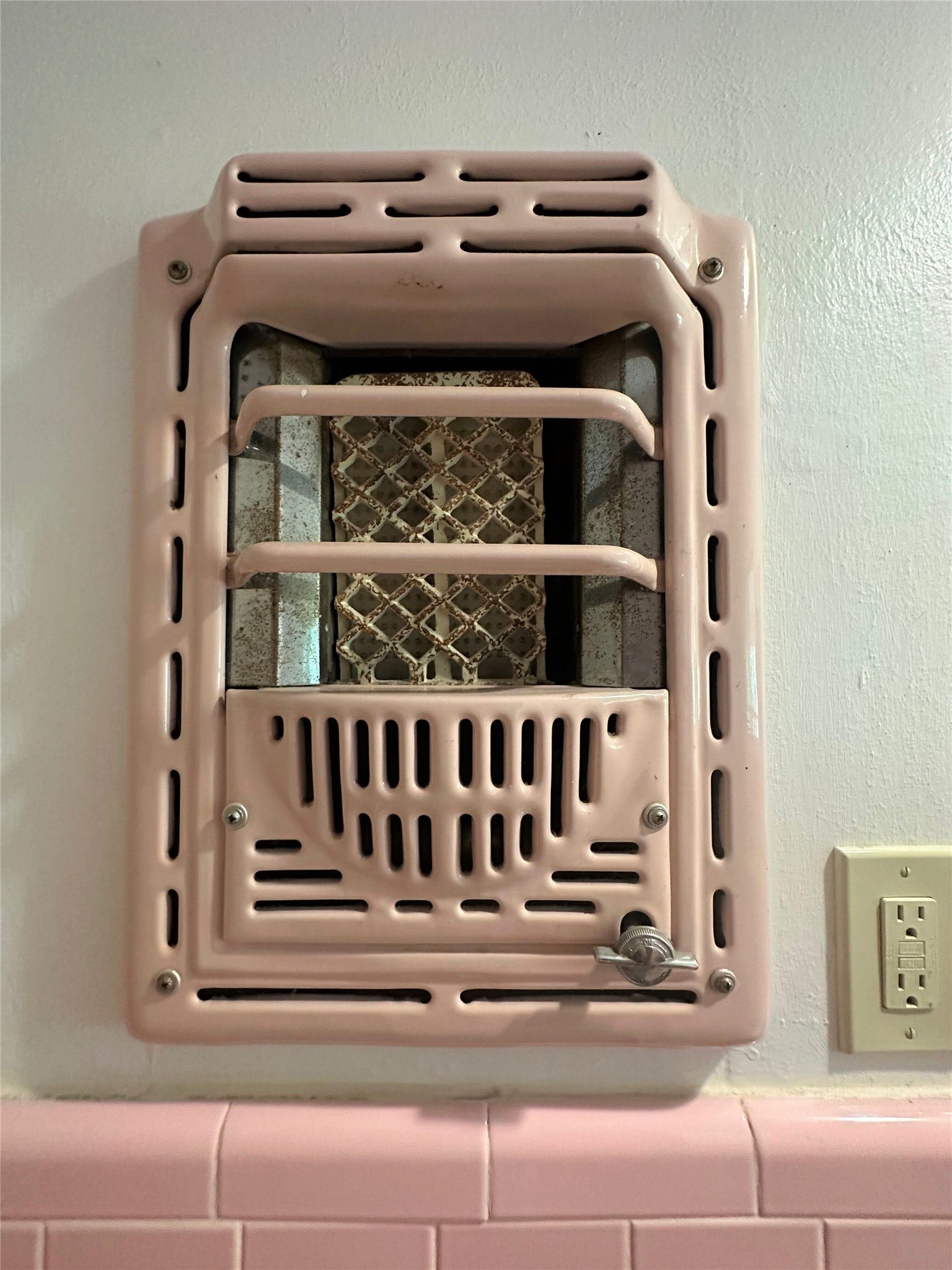 Wall art from the 1940's!  Love that they kept this wall heater in place after upgrading to central heating. Adds so much character!