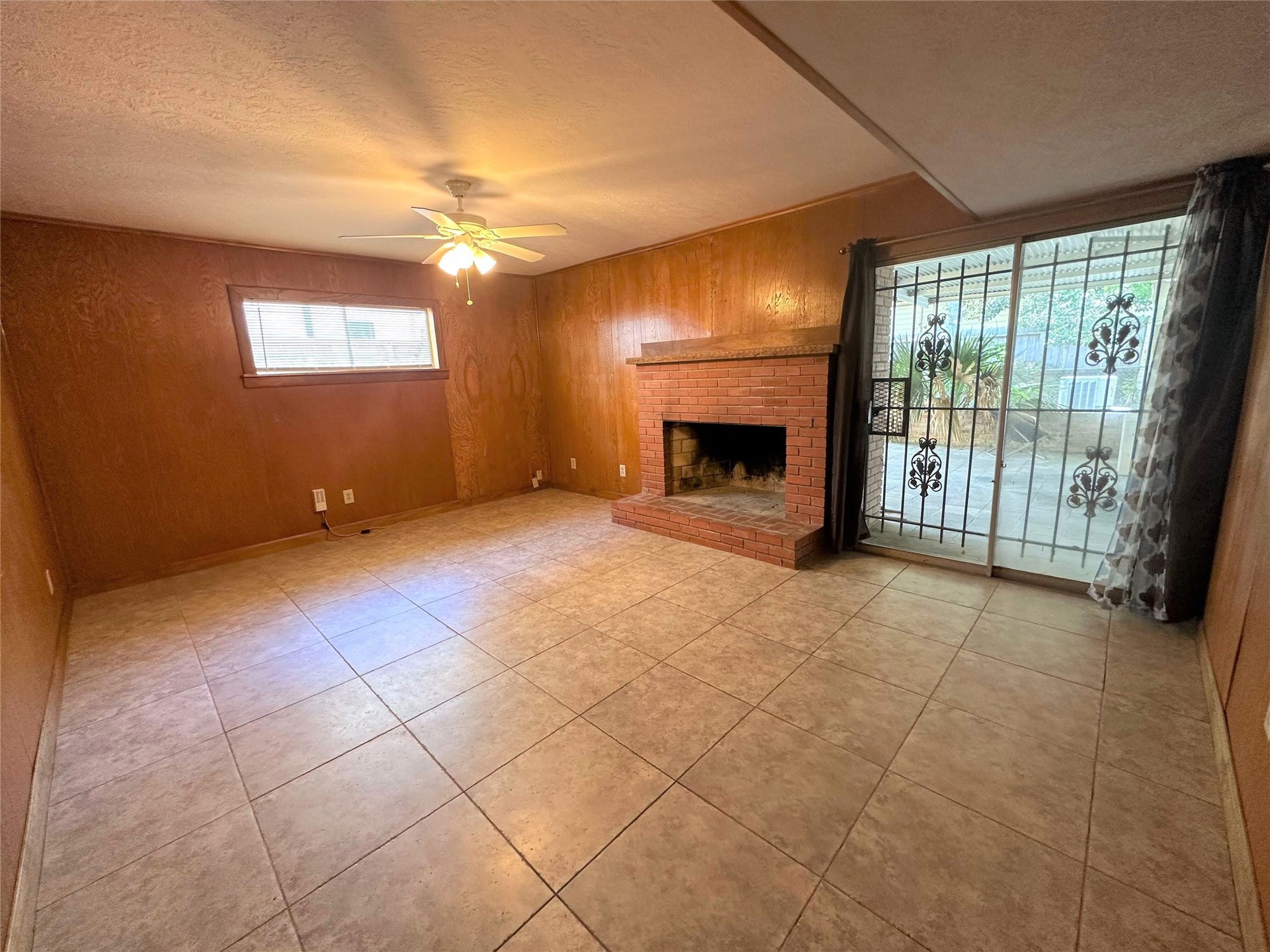 Additional living space/den with fireplace on back side of home.  Great flex space that could be also used for game room or home office.  Sliding glass doors lead to back covered patio.