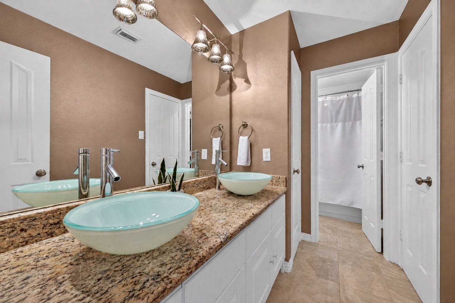 13611 Cottage Arbor Court, Sugar Land, TX 77498 Shared secondary bath serving Bedrooms 2 and 3, featuring a dual vanity with vessel sinks, granite countertops, and a separate tub/shower area for added functionality and convenience.