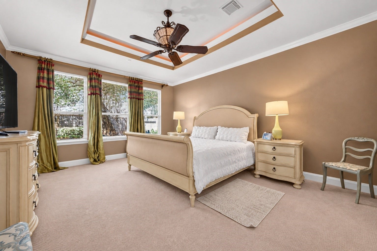 13611 Cottage Arbor Court, Sugar Land, TX 77498 Spacious primary suite featuring a sophisticated tray ceiling with accent lighting, abundant natural light, and plenty of room for a comfortable sitting area.