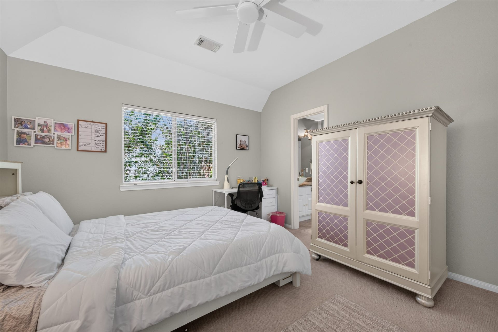 13611 Cottage Arbor Court, Sugar Land, TX 77498 Another view of the spacious upstairs secondary bedroom, highlighting the vaulted ceiling, natural light, and convenient access to the adjoining bath.