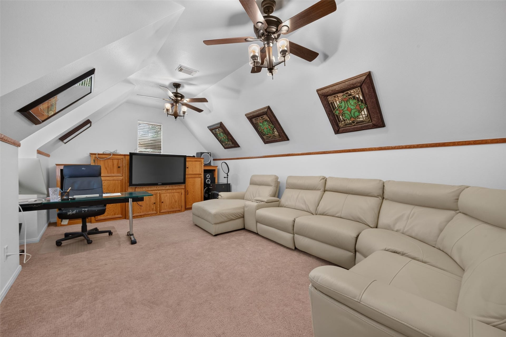 13611 Cottage Arbor Court, Sugar Land, TX 77498 Spacious second-floor media/game room with vaulted ceilings, offering plenty of room for entertainment, lounging, and a dedicated workspace.