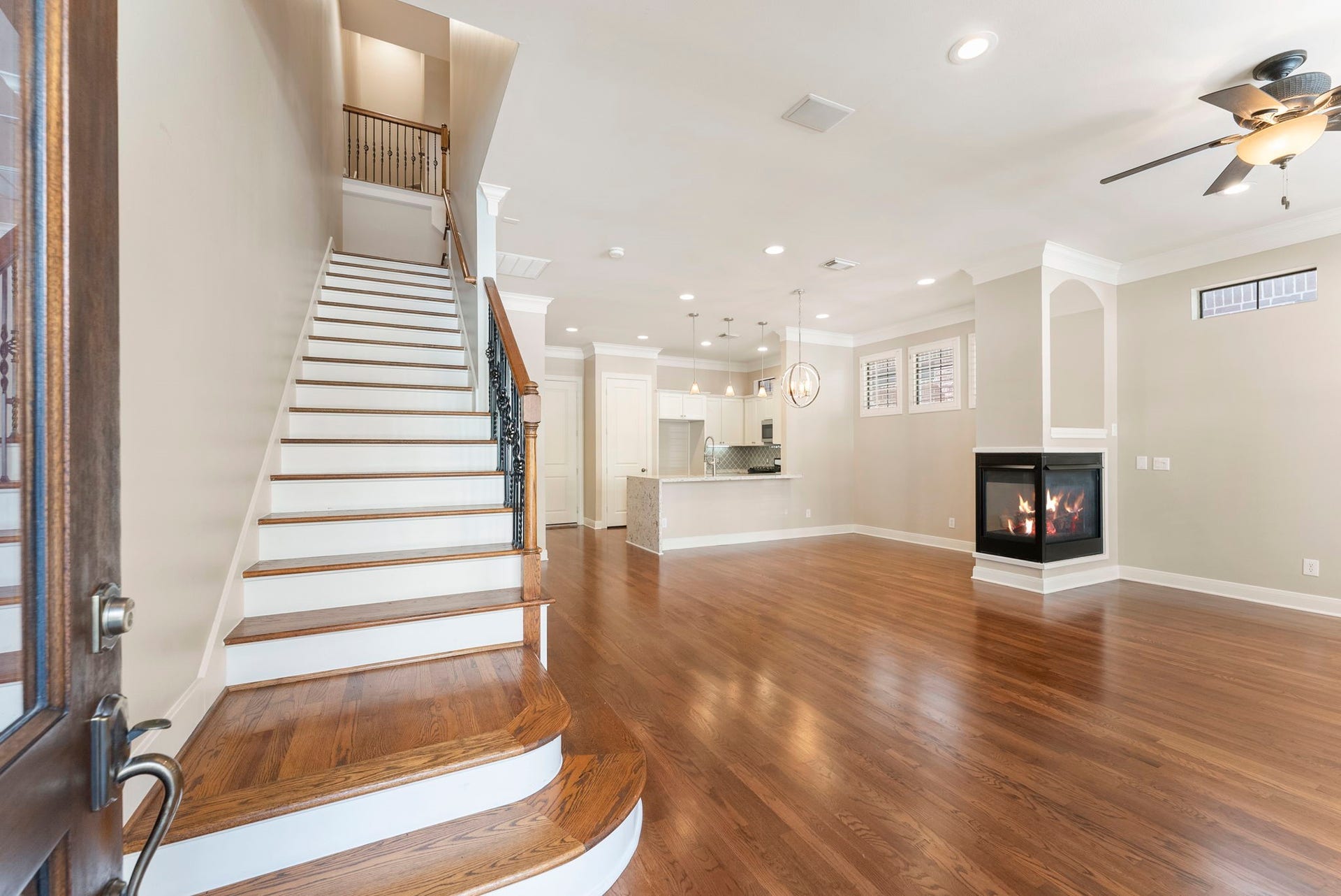 24 Riva Row, Spring, TX 77380 Gleaming hardwoods, crown molding, and a three-sided fireplace greet you the moment you walk in.