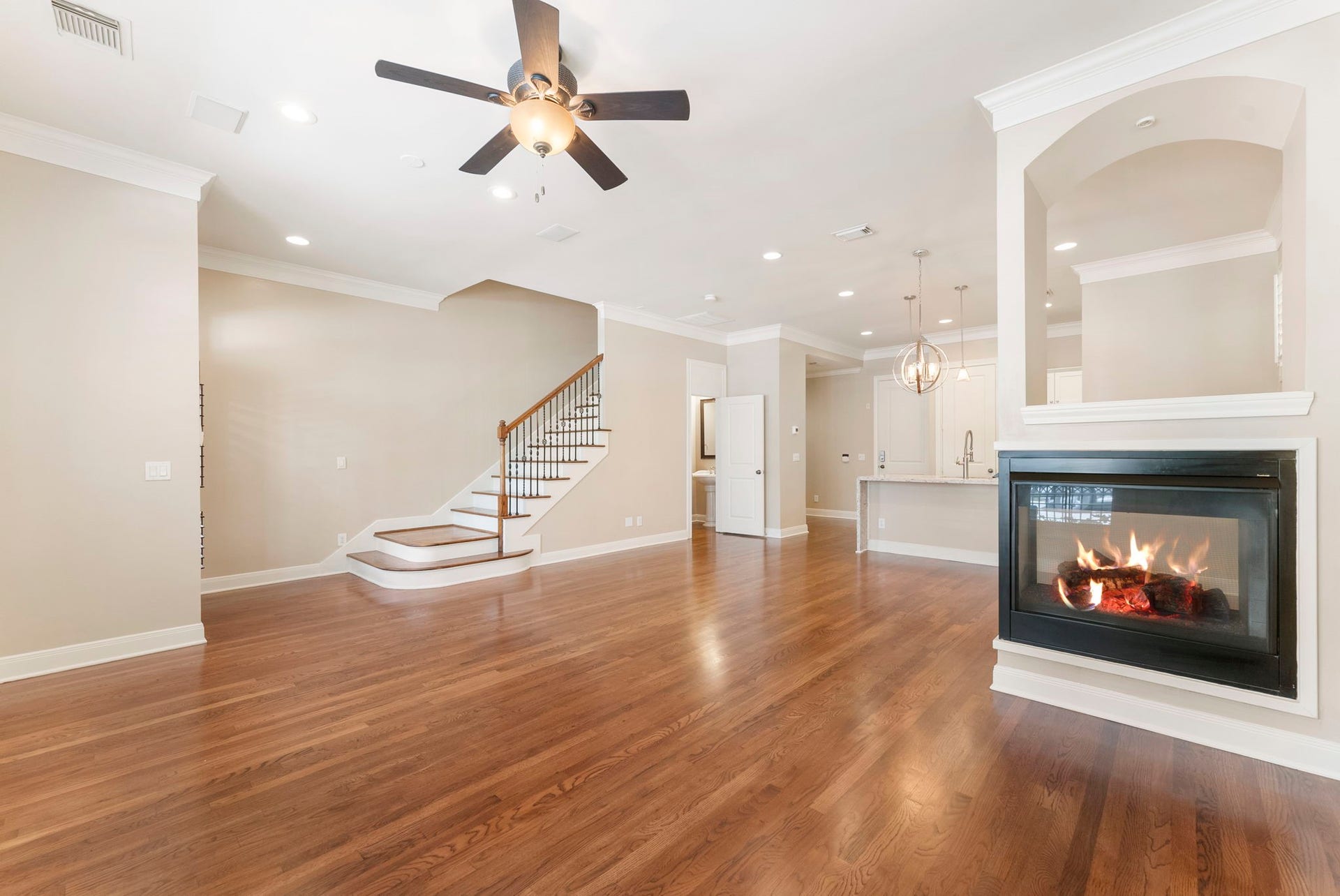 24 Riva Row, Spring, TX 77380 A spacious, open main level with a statement fireplace, crown molding, and easy flow to the kitchen.