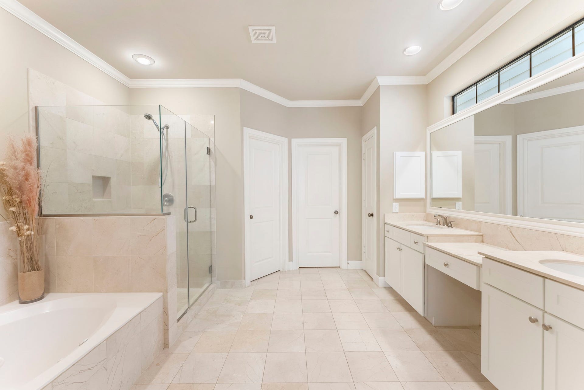 24 Riva Row, Spring, TX 77380 The spacious primary bath features a separate tub and shower, double vanities, and plenty of storage.
