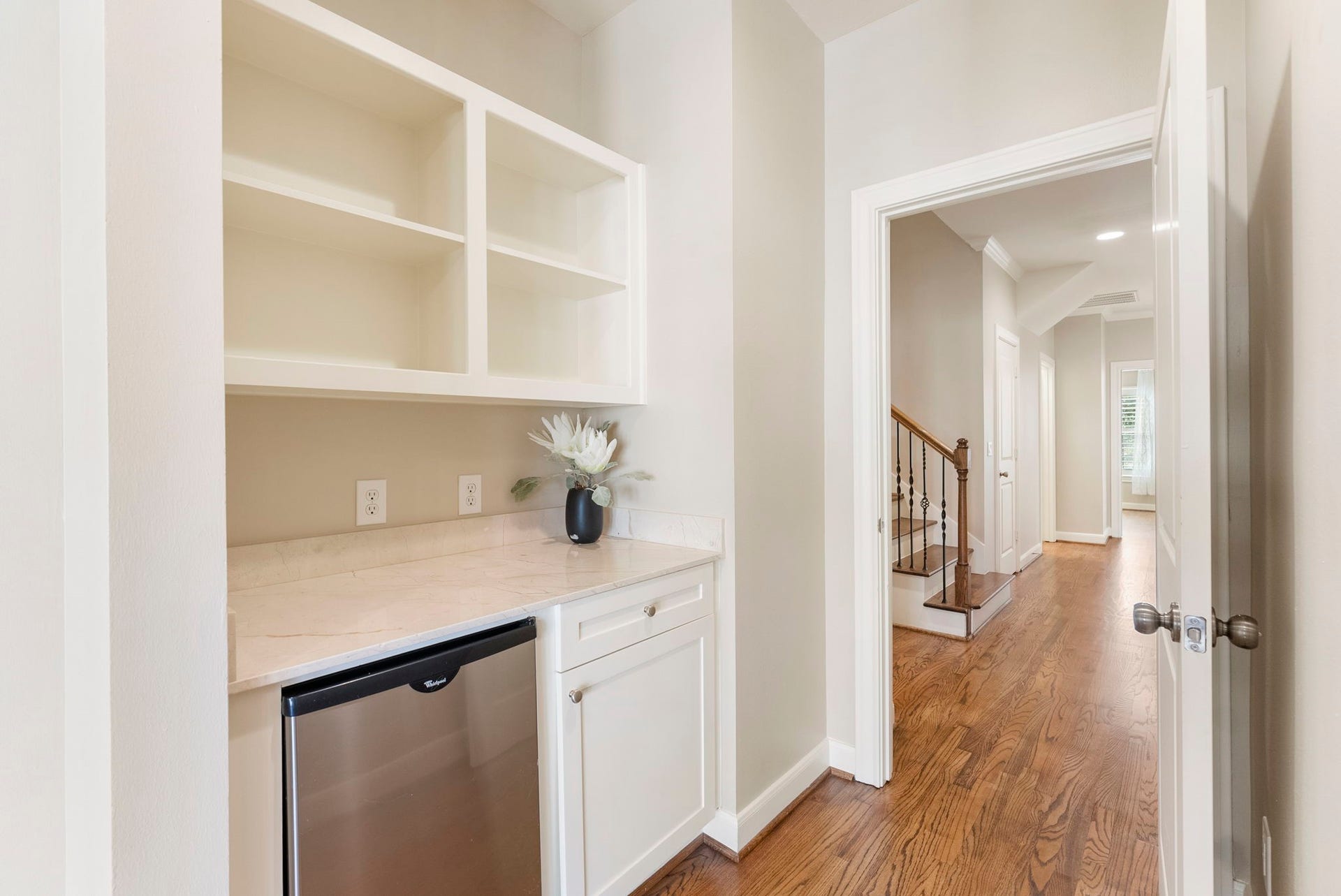 24 Riva Row, Spring, TX 77380 A private beverage station welcomes you into the primary suite, with a view back down the second-floor hallway.