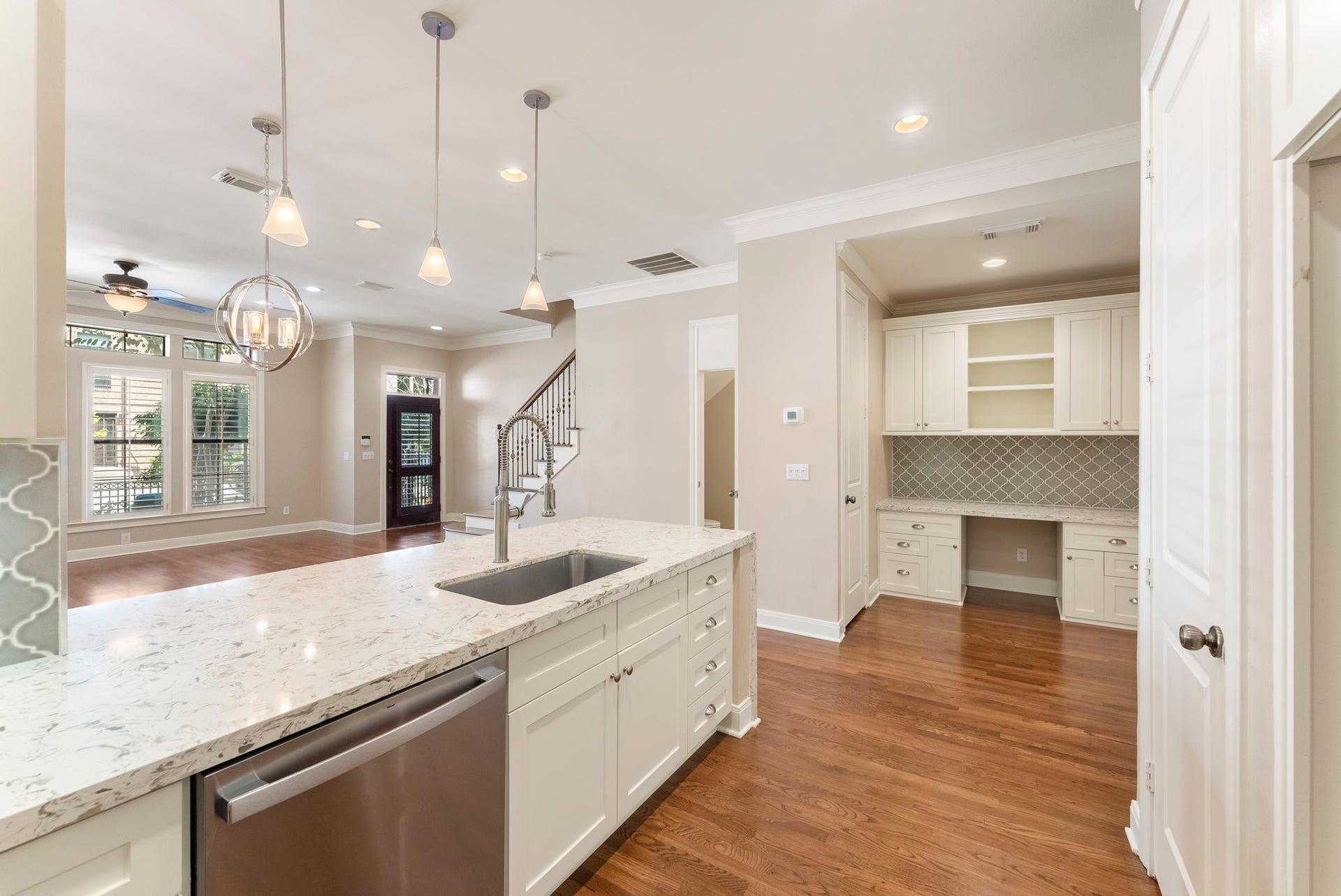 24 Riva Row, Spring, TX 77380 A built-in desk with matching cabinetry and backsplash makes a perfect home office or command center.