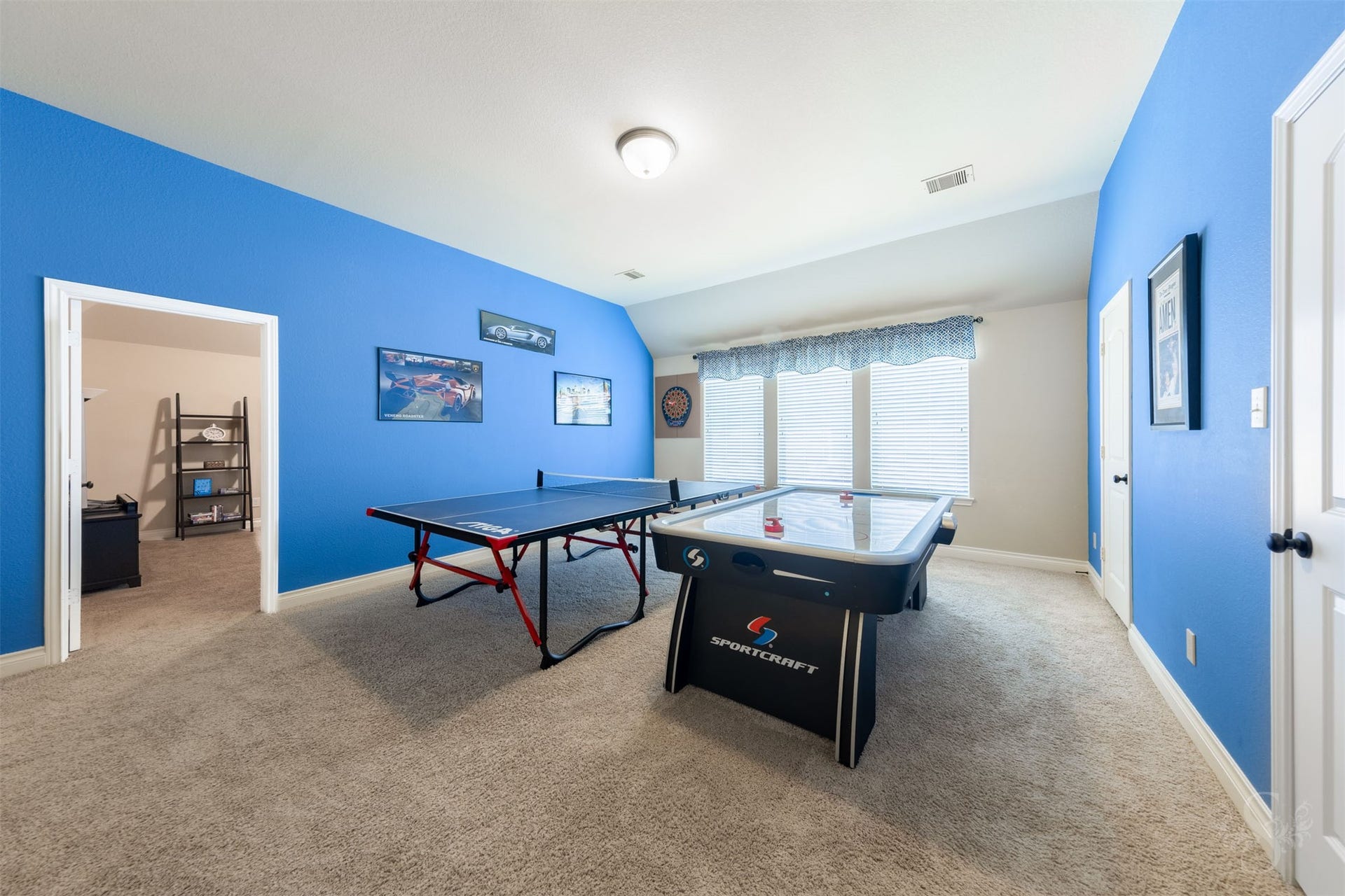 5219 Kenton Place Lane, Fulshear, TX 77441 The expansive upstairs game room offers generous space for table tennis, air hockey and friendly competition. A wall of windows brightens this inviting gathering place, ready for hours of family fun.
