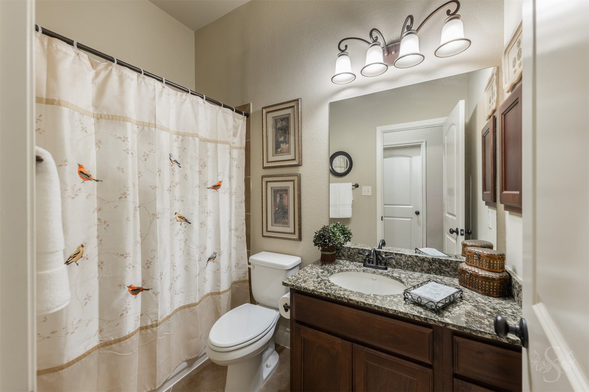 5219 Kenton Place Lane, Fulshear, TX 77441 The full bath downstairs features a beautiful granite vanity and richly stained cabinetry that complement the homes style. A tub and shower combination provides everyday convenience.