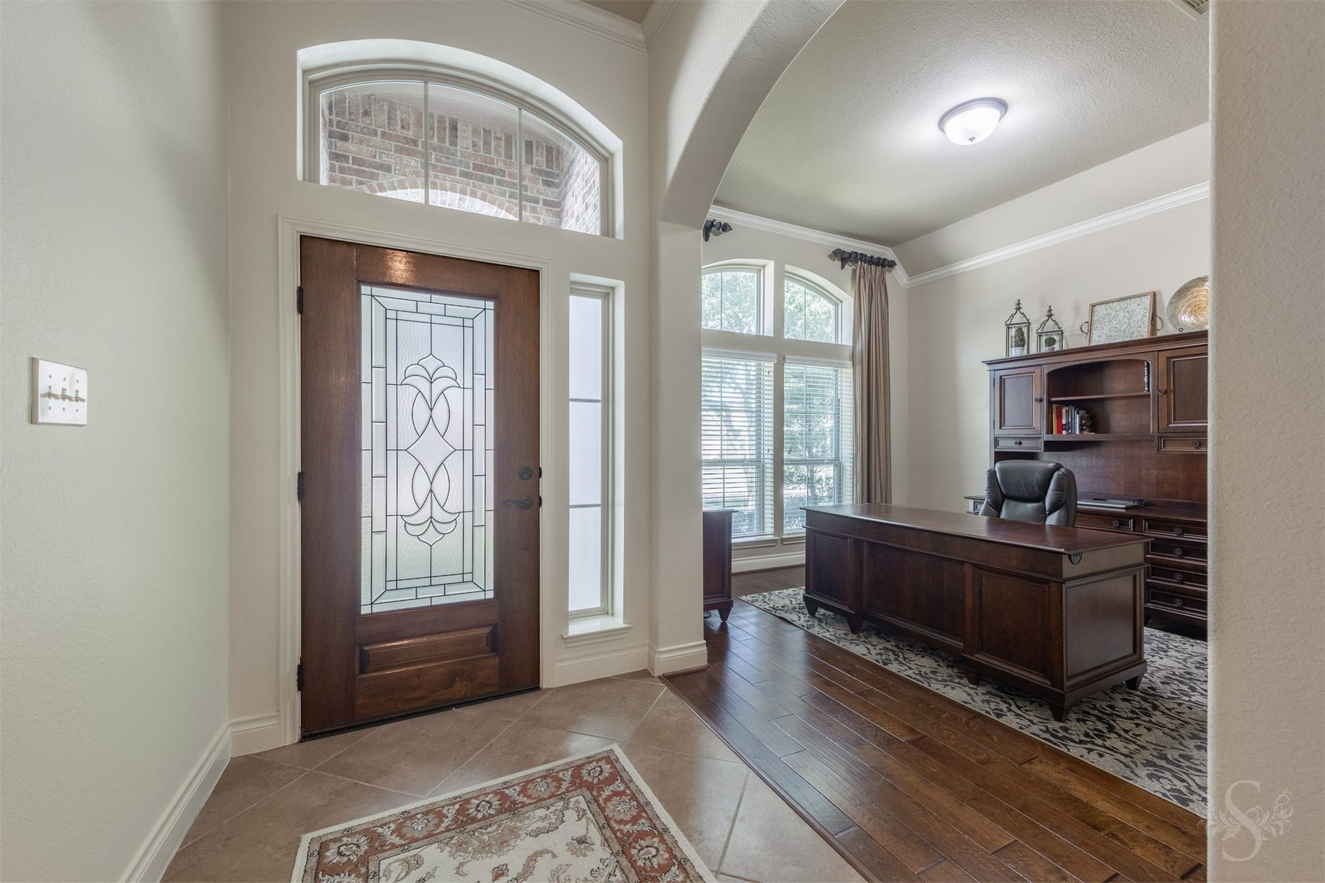 5219 Kenton Place Lane, Fulshear, TX 77441 A decorative glass front door and arched transom introduce an elegant entry accented by diagonal tile flooring. Just off the entry, a graceful archway opens to the study, where rich wood flooring and an expansive front window create a warm, inviting workspace.