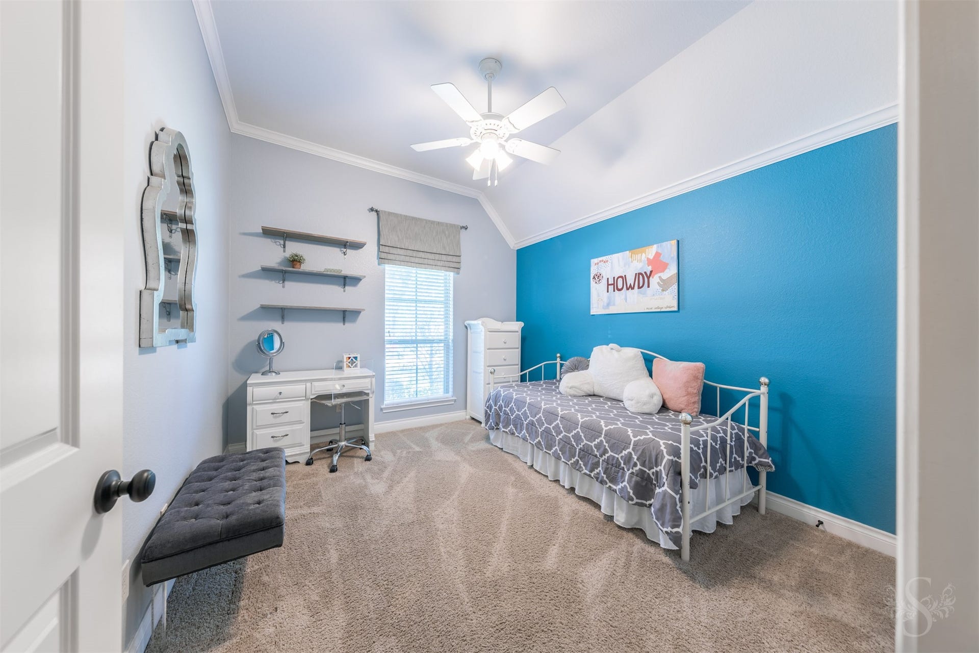 5219 Kenton Place Lane, Fulshear, TX 77441 A high, angled ceiling gives this charming secondary bedroom an airy feel, while a tall window brightens the space. There is ample room for a cozy bed and a desk, creating a welcoming place to rest, study and enjoy quiet time.