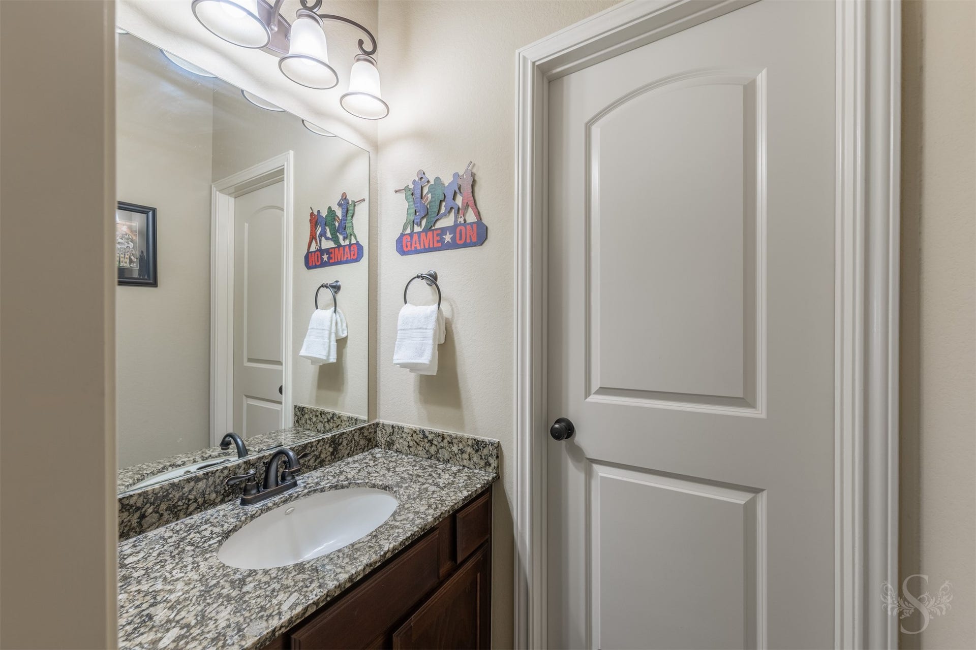 5219 Kenton Place Lane, Fulshear, TX 77441 The Hollywood bath features a granite vanity and richly stained cabinetry for an elegant, polished look. A separate vanity area makes busy mornings easier while providing added privacy.