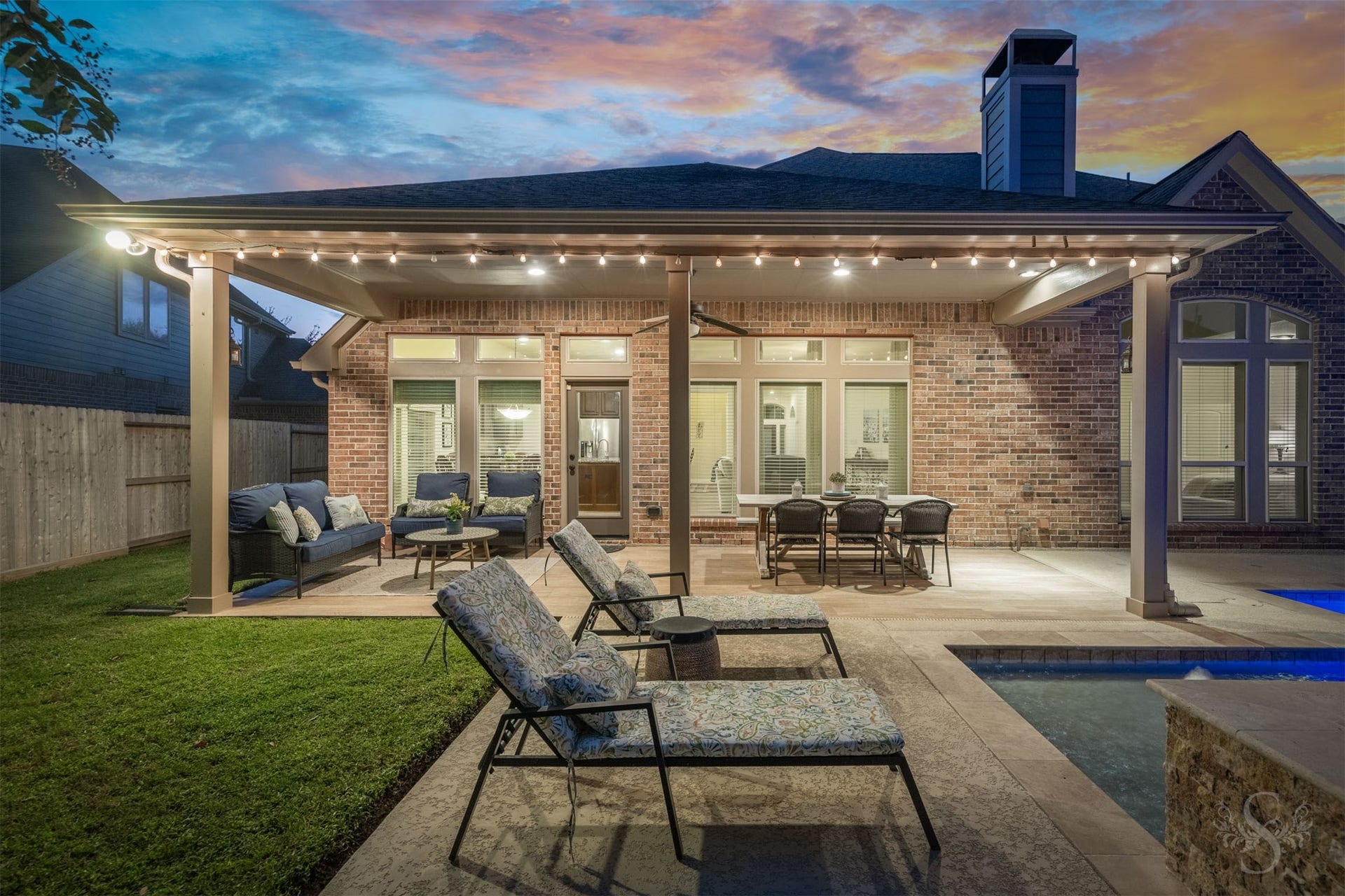 5219 Kenton Place Lane, Fulshear, TX 77441 The covered patio creates a luxurious outdoor gathering space with generous room for lounging and dining beside the pool. Enjoy leisurely dinners and relaxed conversation as the evening unfolds in this beautifully appointed backyard retreat.