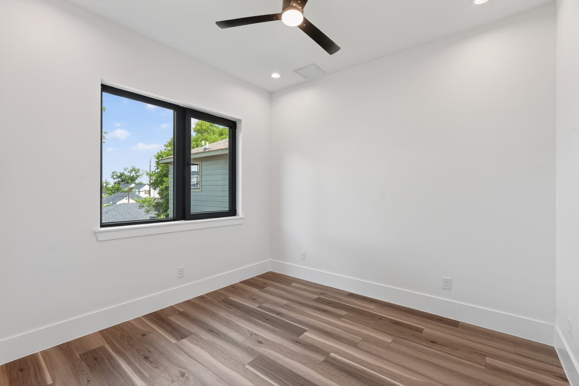 Bright and versatile guest suite featuring abundant natural light, generous closet space, and a flexible layout ideal as a guest bedroom or home office.