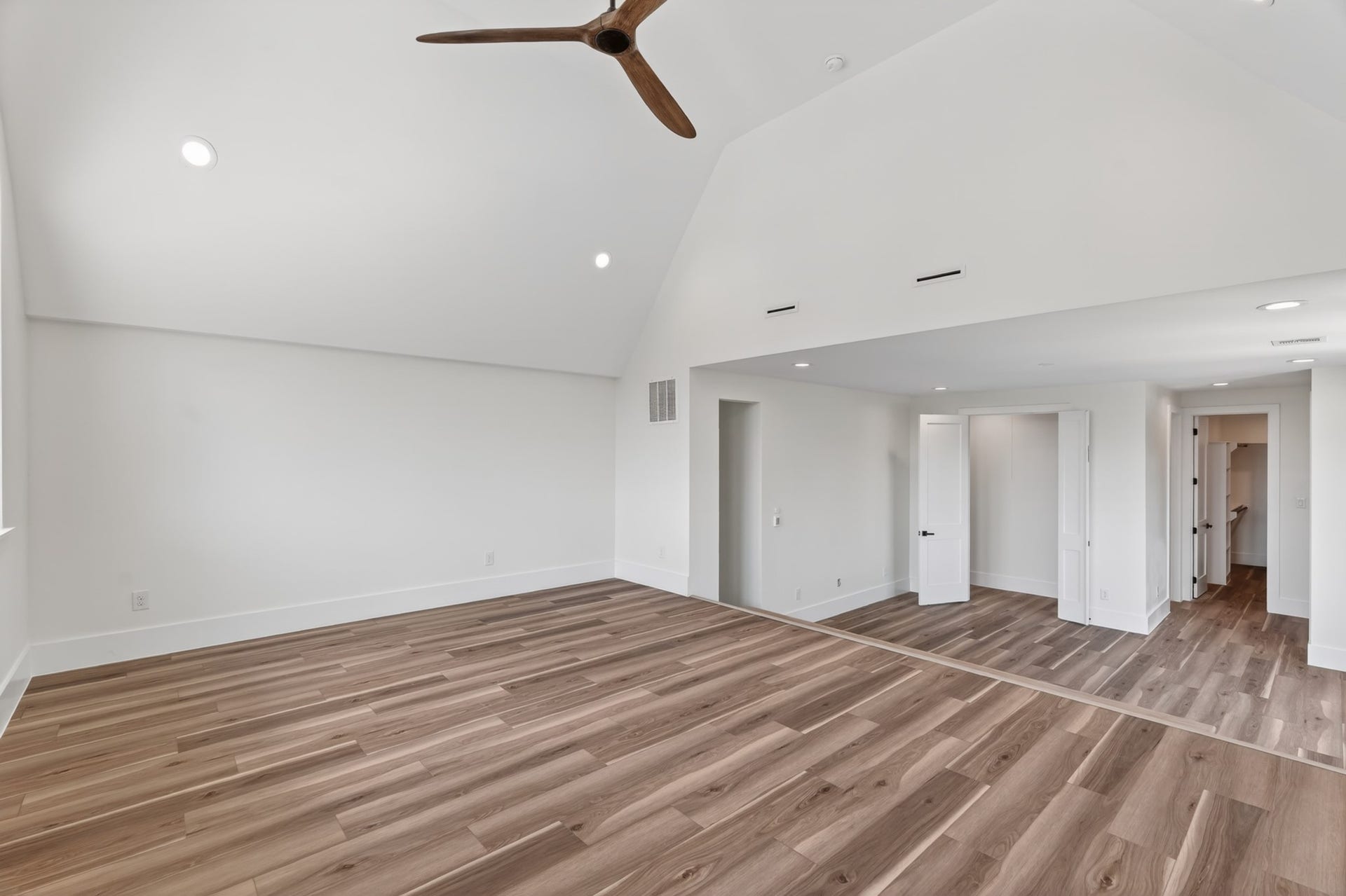 One-of-a-kind third-floor primary retreat spanning the entire level, with a versatile two-level layout perfect for a sleeping area, media room, home office, gym, or reading nook
